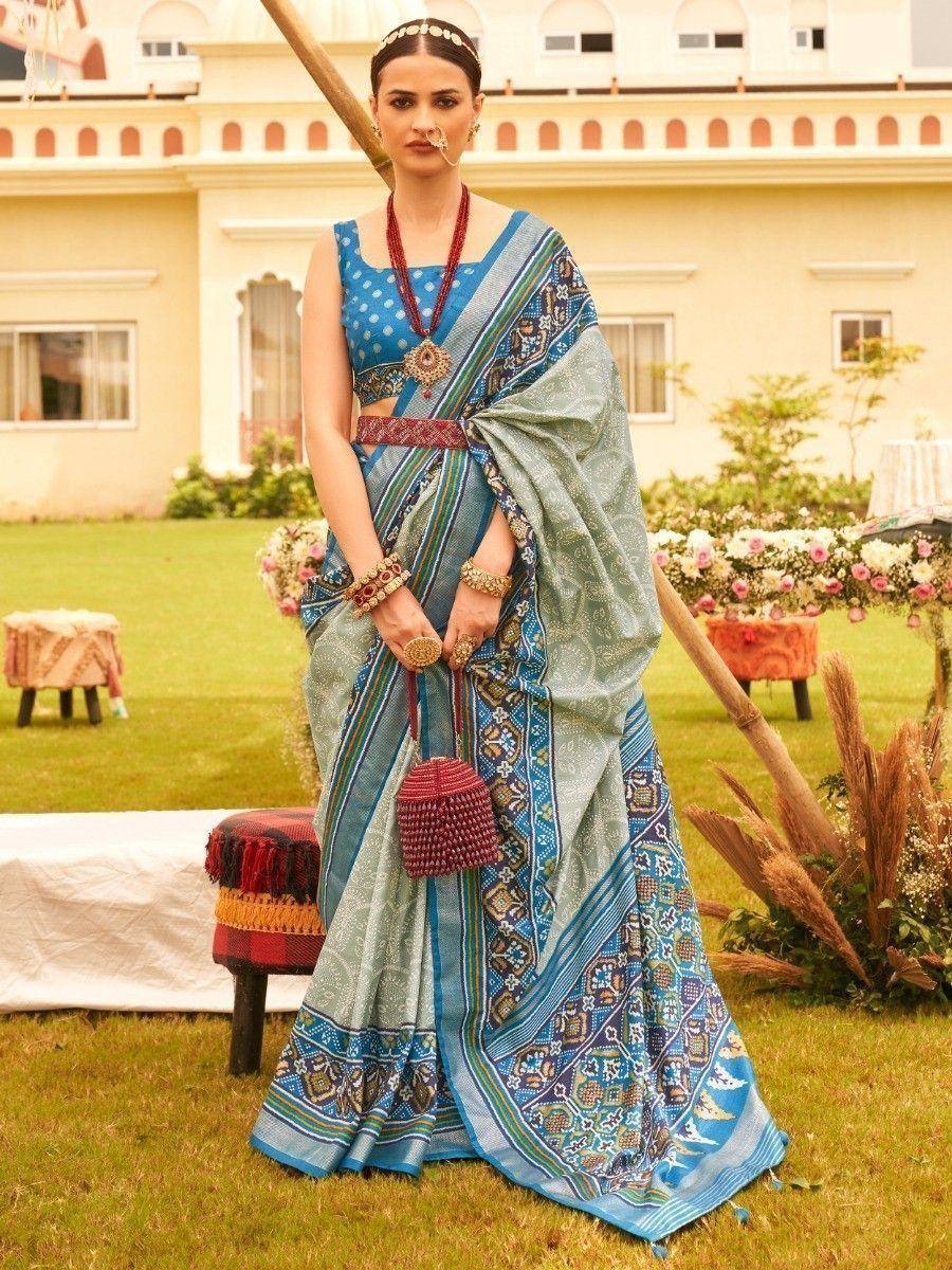 Blue printed saree with matching blouse, ethnic jewelry, and traditional nath, perfect for Indian weddings or festivals