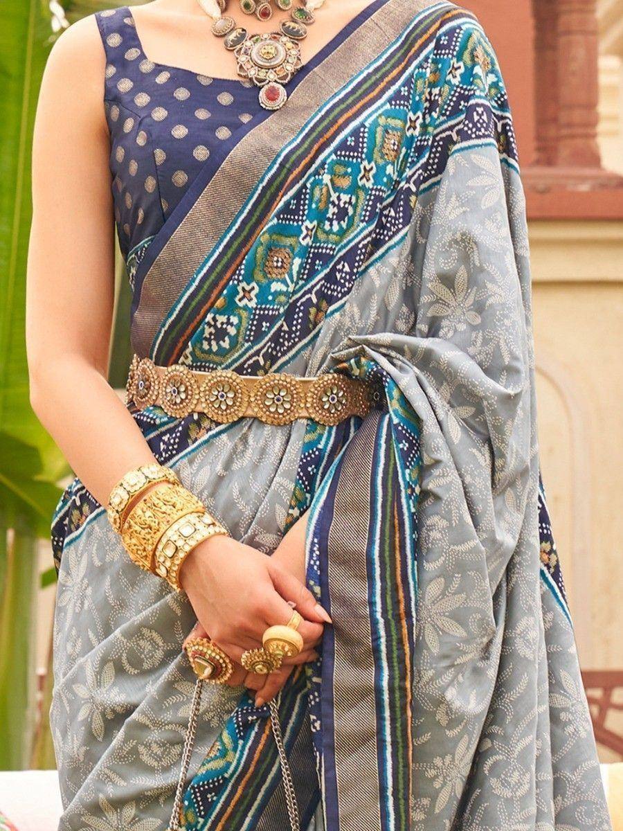 Blue and grey printed saree with gold belt and ethnic jewelry, perfect for Indian occasions