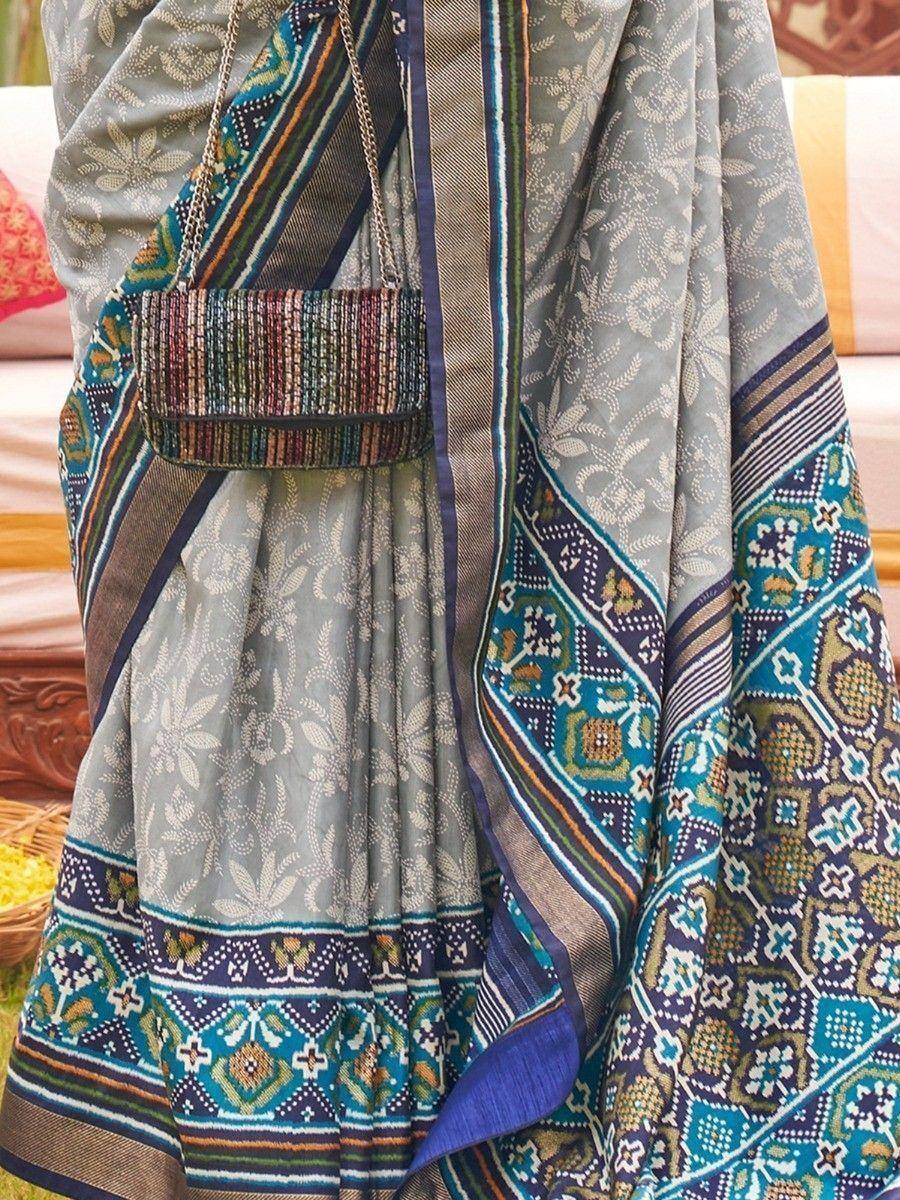 Grey floral saree with blue border and matching beaded clutch, Indian ethnic wear