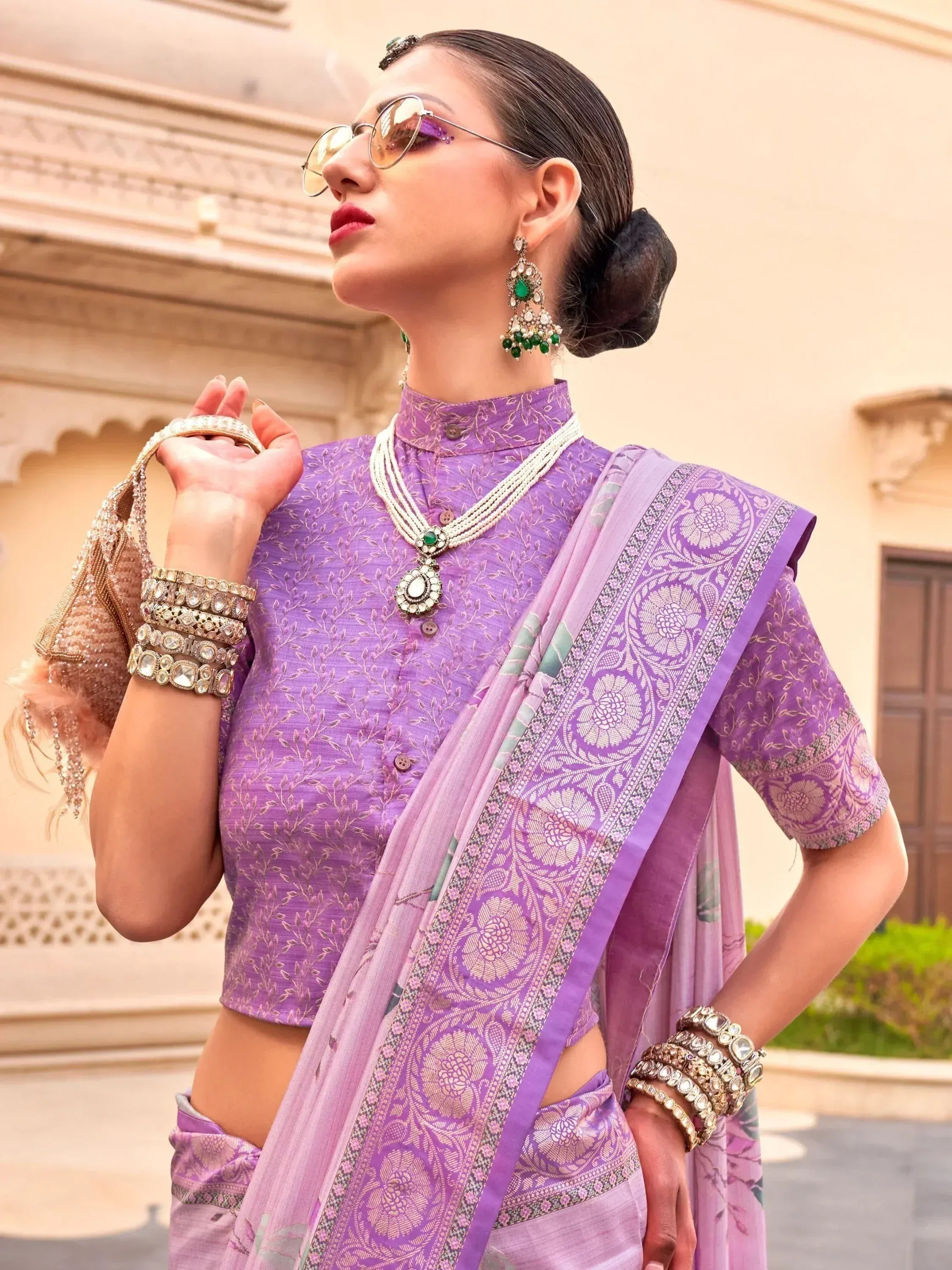 Purple designer saree with embroidered blouse, traditional jewelry, and sunglasses for ethnic wear