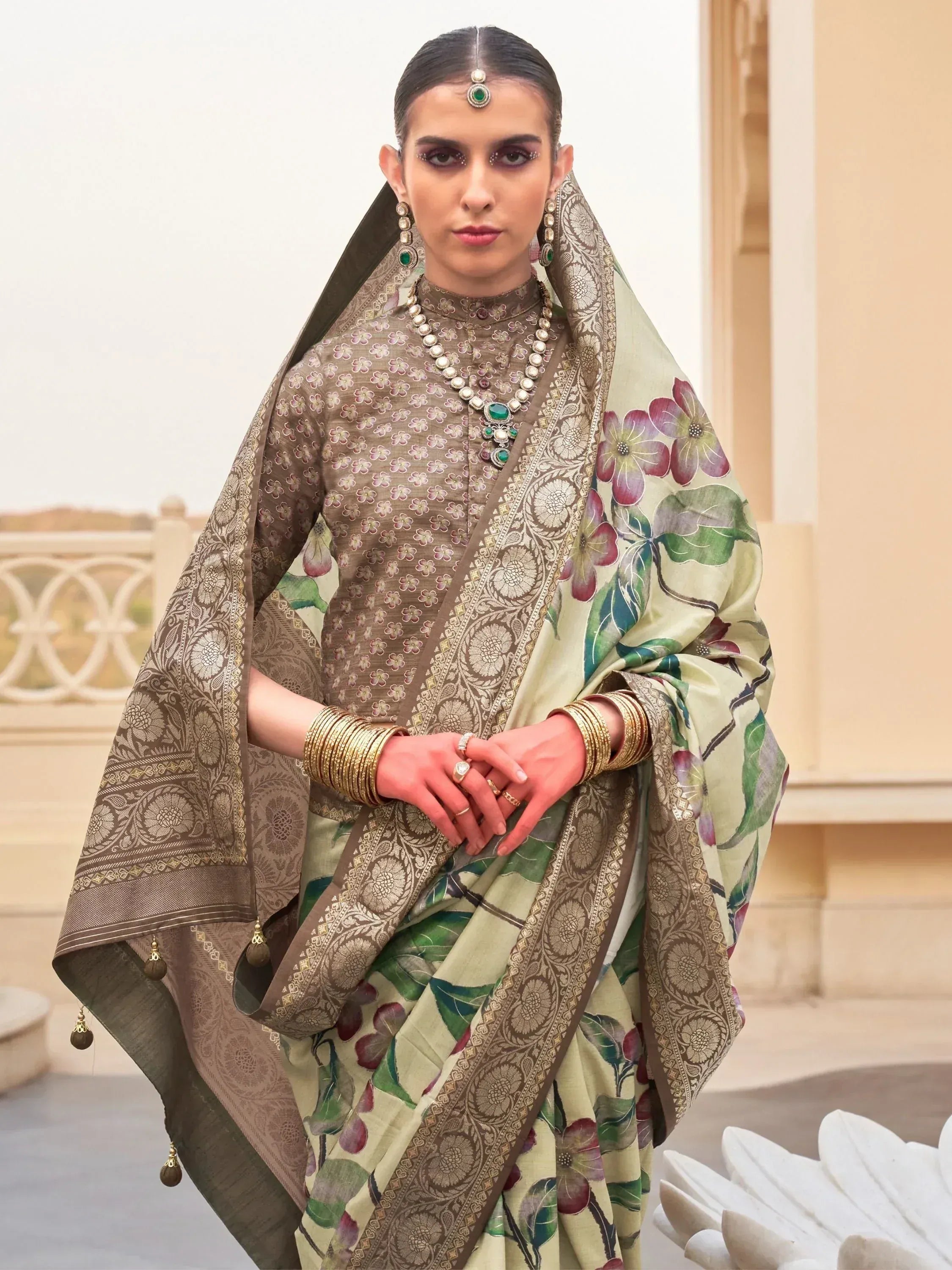 Elegant Indian ethnic saree with floral print and gold embroidery, paired with traditional jewelry