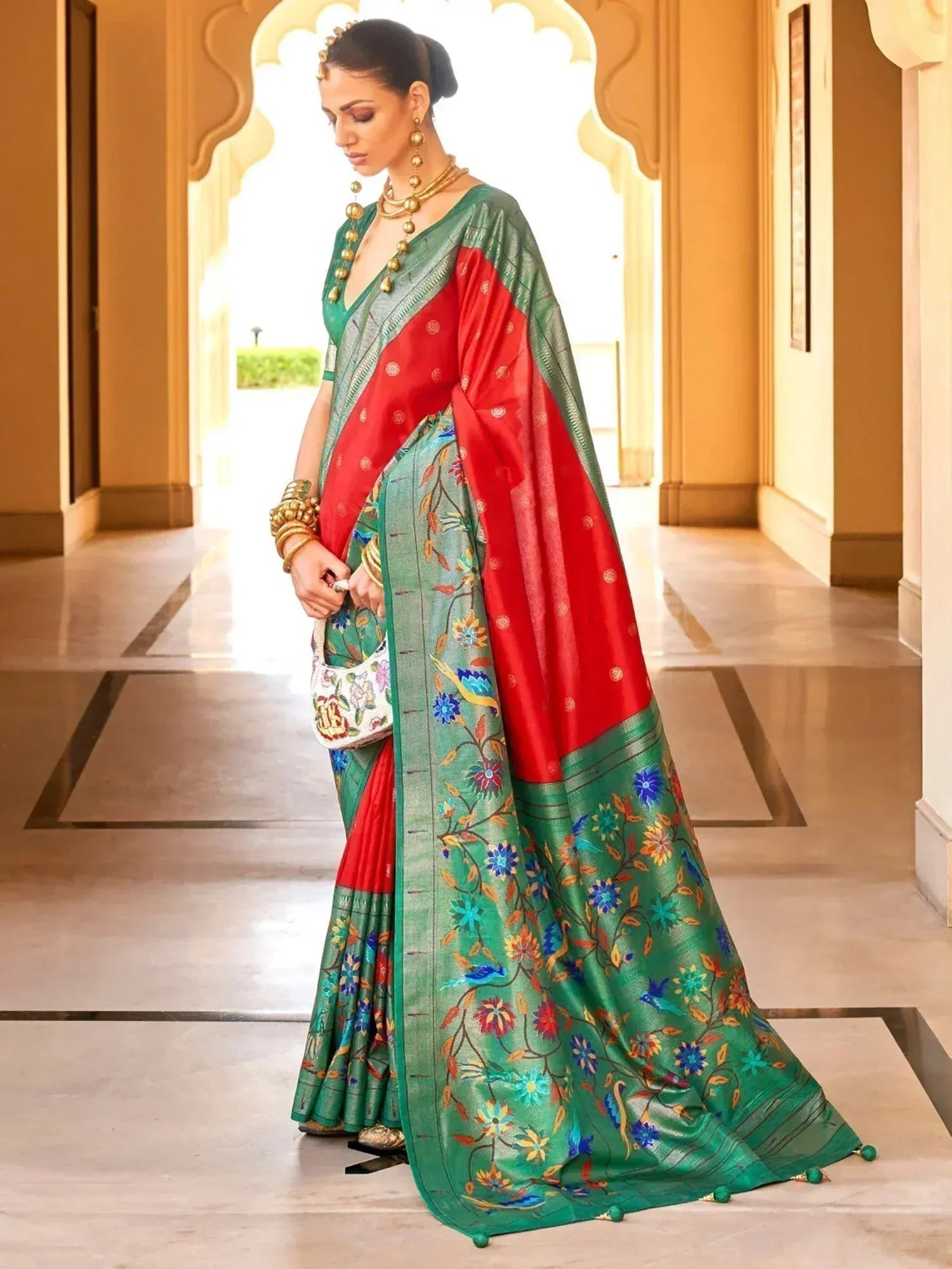 Green and red floral embroidered saree with gold jewelry, perfect for Indian ethnic wear occasions