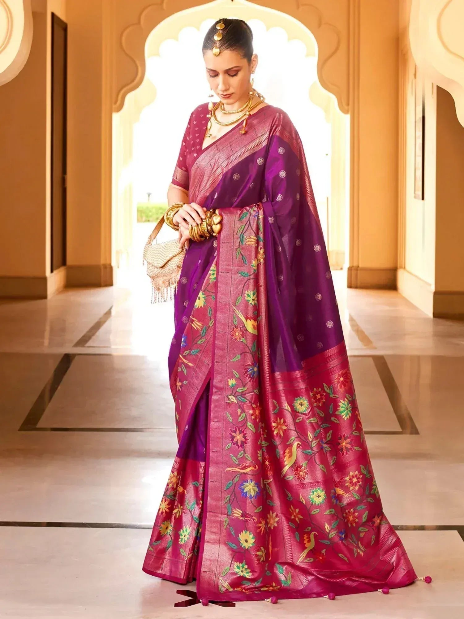 Purple and pink floral embroidered saree with gold jewelry, perfect for Indian ethnic occasions
