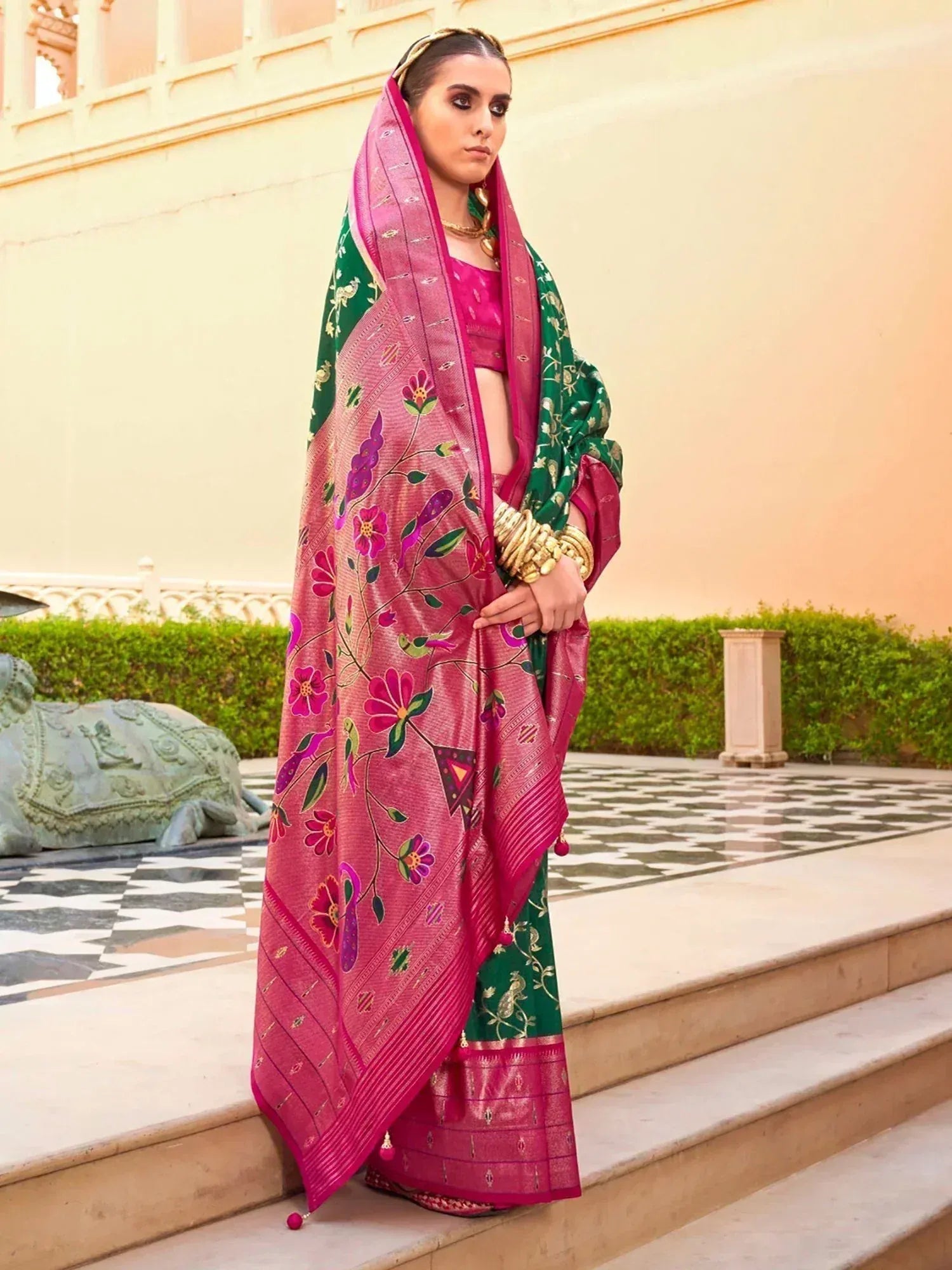 Pink and green floral printed saree with gold jewelry, styled for Indian ethnic wear