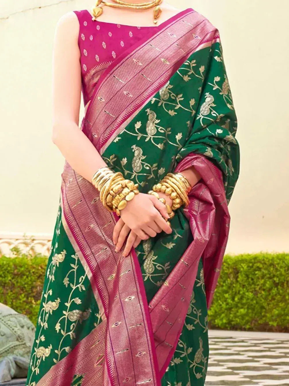 Green and pink embroidered saree with peacock motifs, gold jewelry, perfect for Indian ethnic occasions