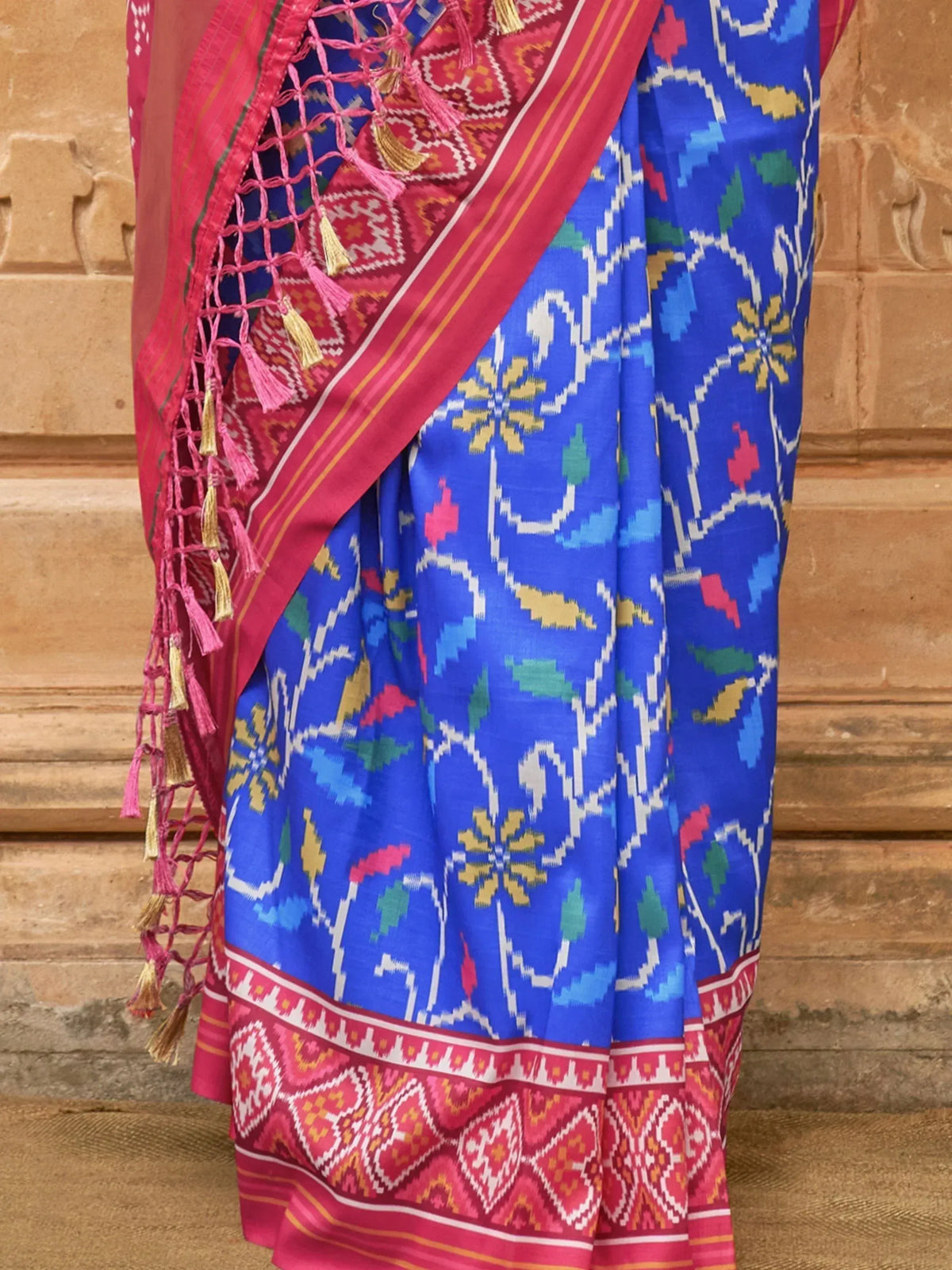 Blue and pink ethnic saree with floral ikat print and tassel border, traditional Indian wear