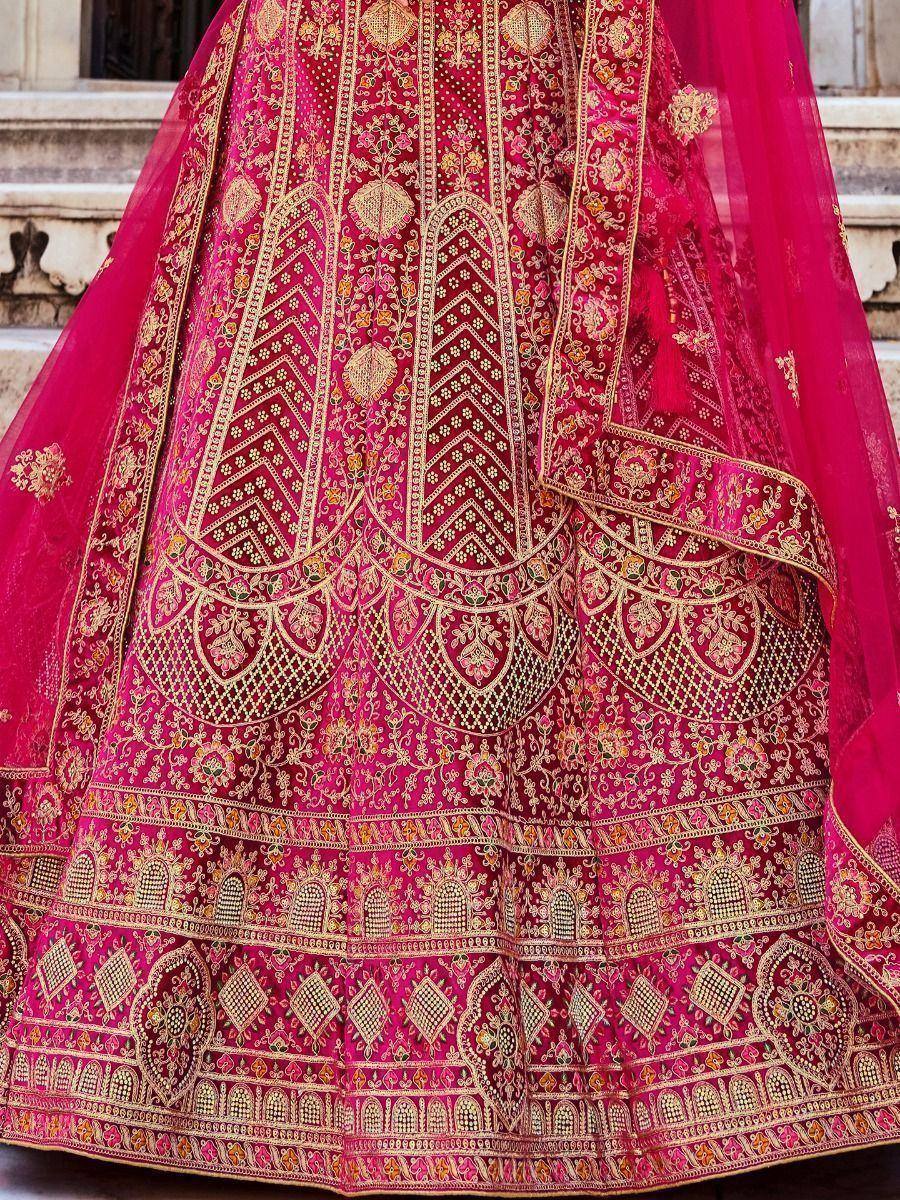 Pink designer lehenga with intricate gold embroidery and floral patterns, perfect for Indian weddings