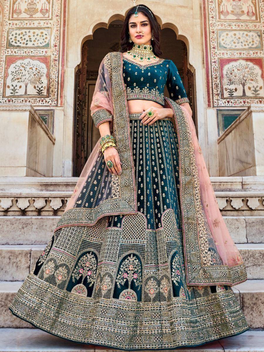 Elegant teal designer lehenga choli with gold embroidery, perfect for Indian weddings and festive occasions.