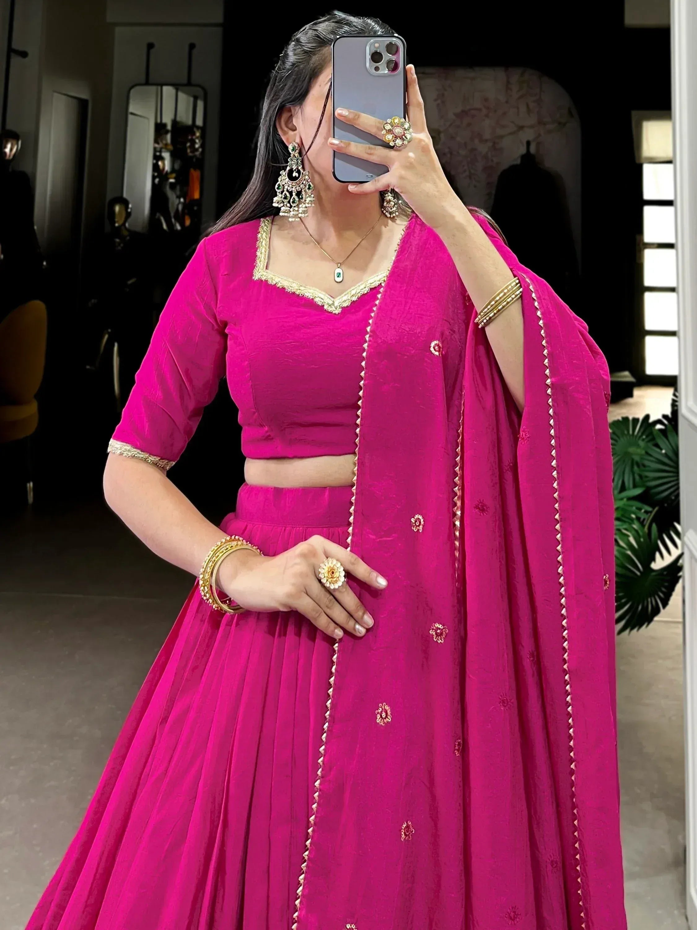 Vibrant pink Indian lehenga choli with gold embroidery, perfect for weddings and festive occasions.