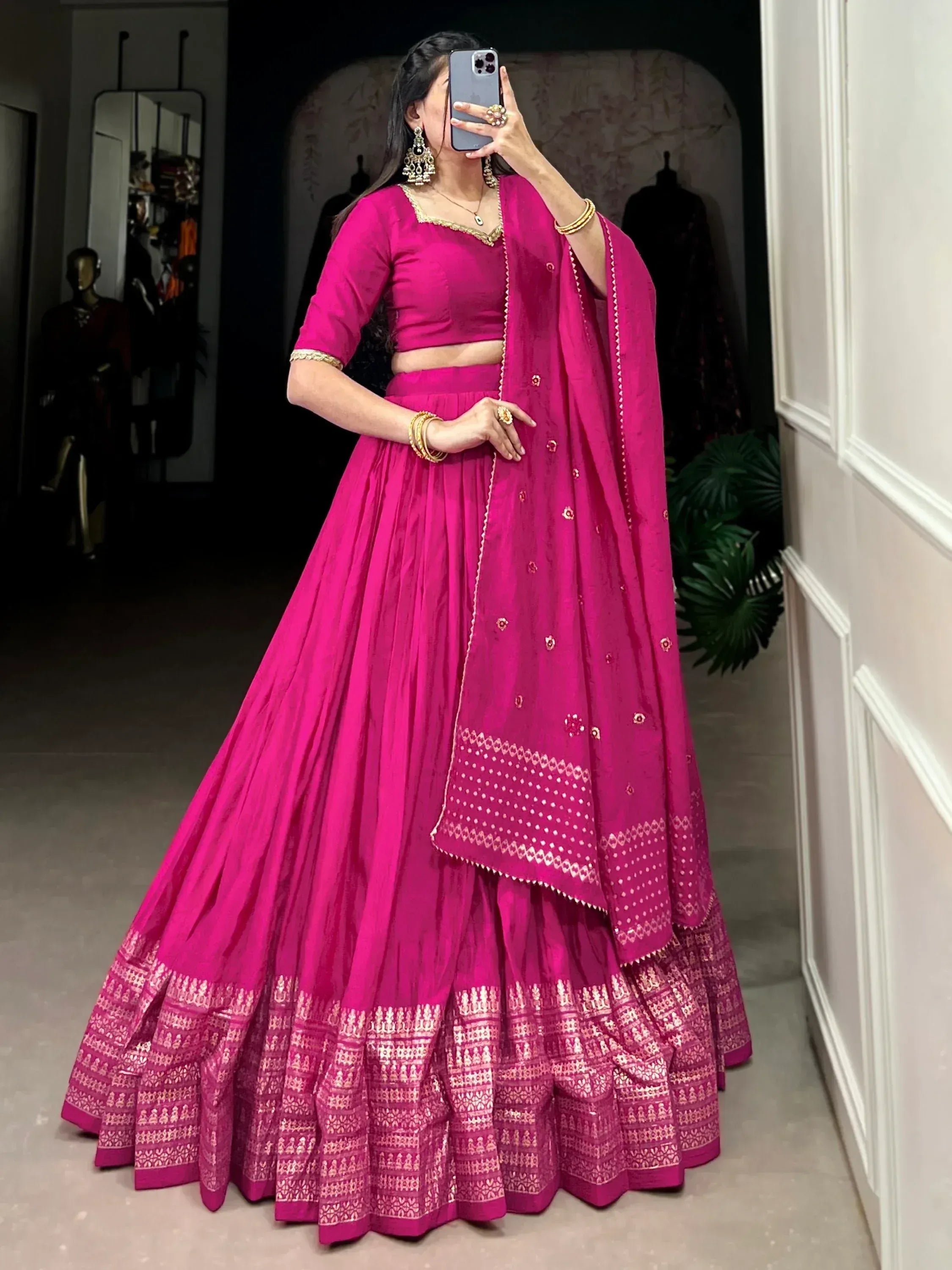 Fuchsia pink lehenga choli with gold embroidery, perfect for Indian weddings and festive occasions.
