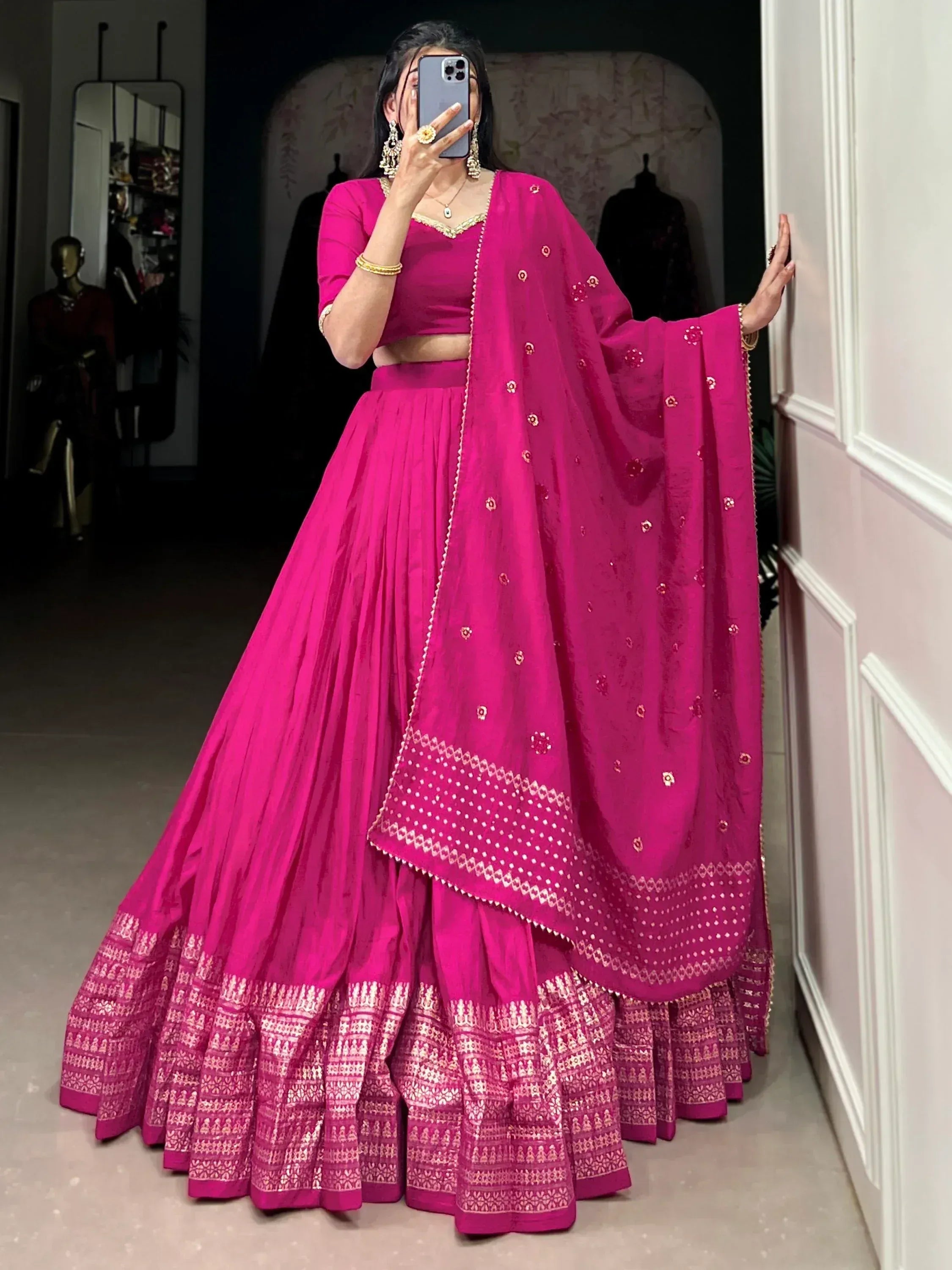 Fuchsia pink lehenga choli with gold embroidery and dupatta, perfect for Indian weddings and festive occasions