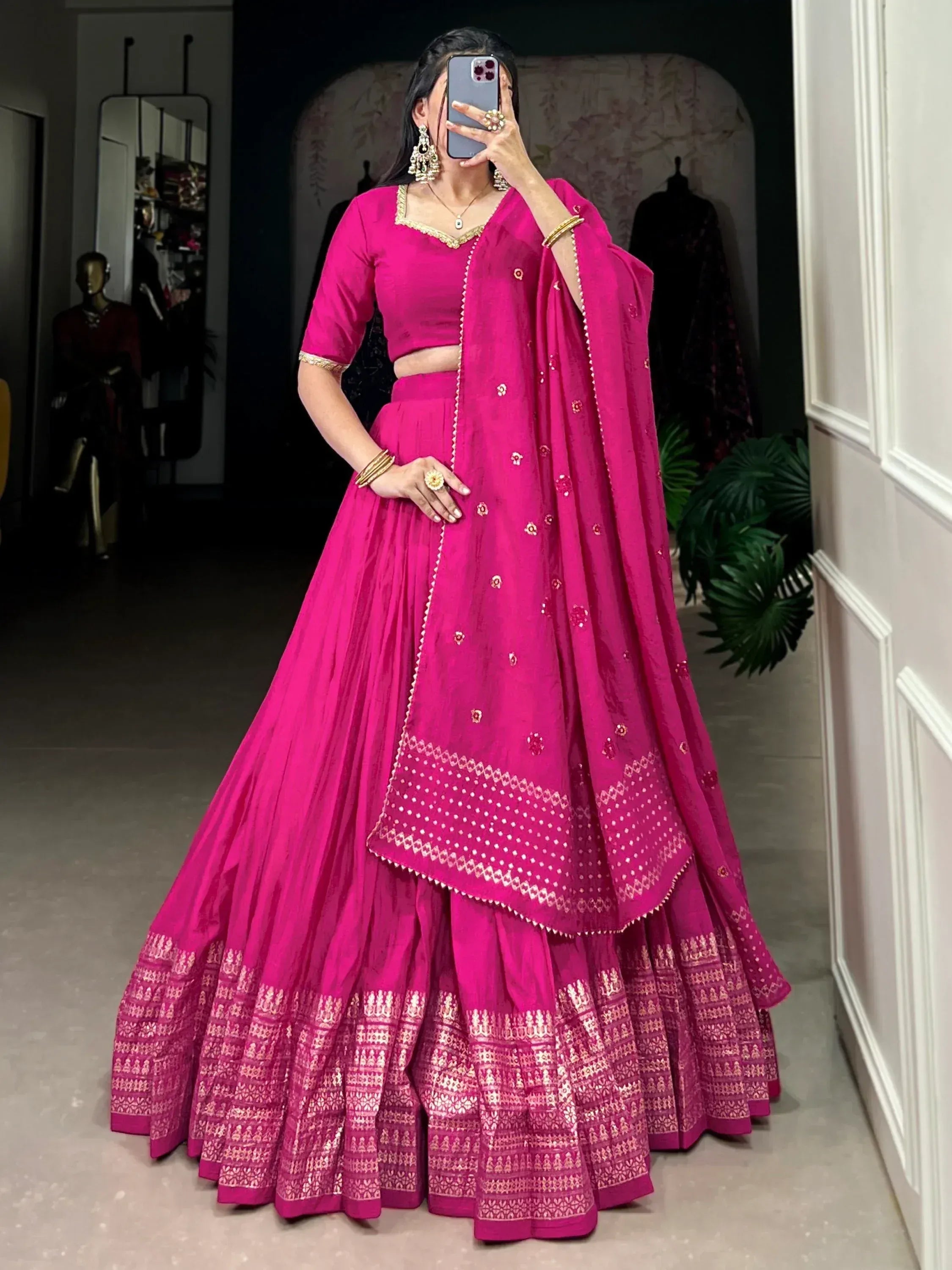 Fuchsia pink lehenga choli with gold embroidery, perfect for Indian weddings and festive occasions.