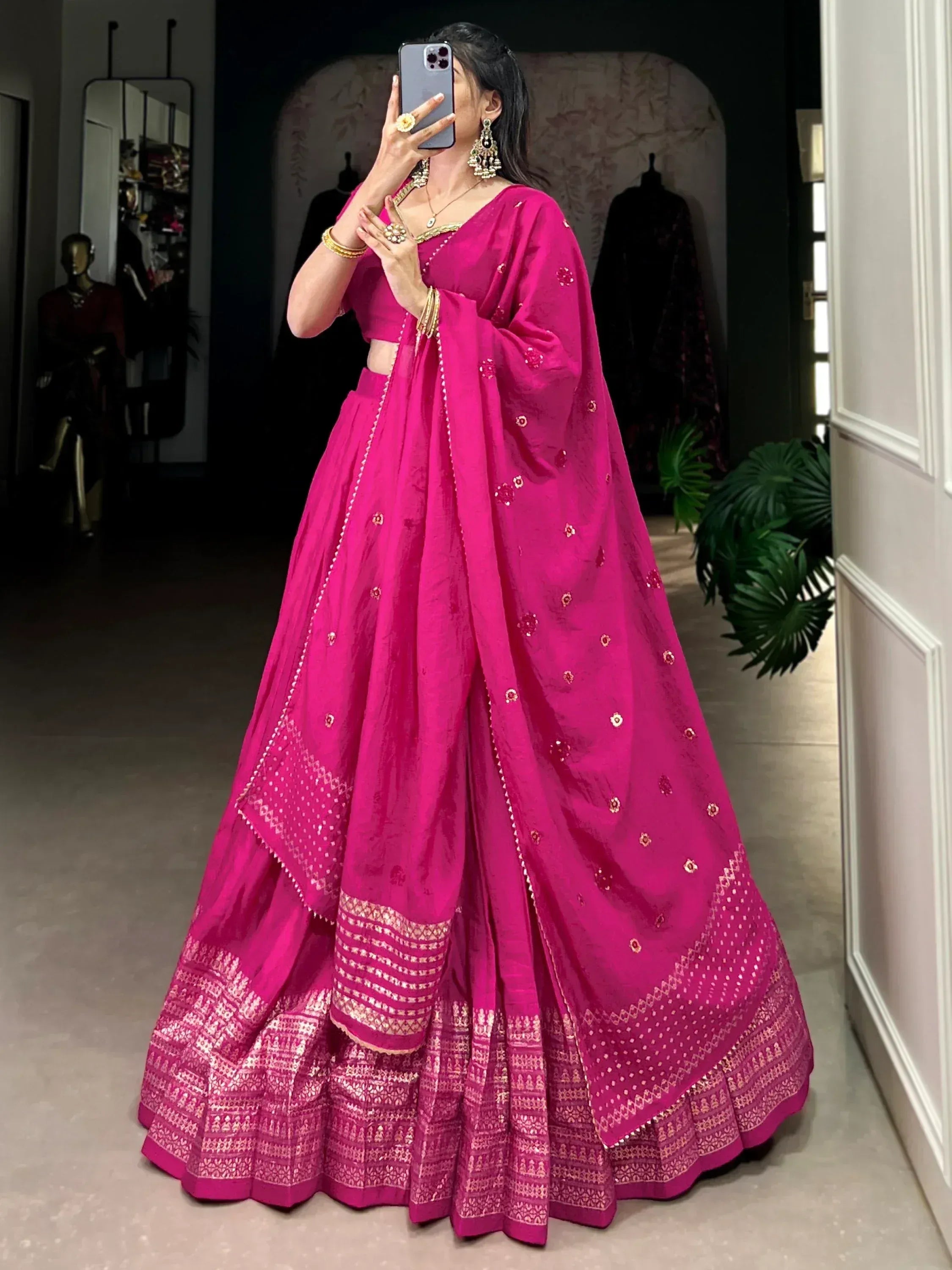 Vibrant pink designer lehenga choli with gold embroidery, perfect for Indian weddings and festive occasions.