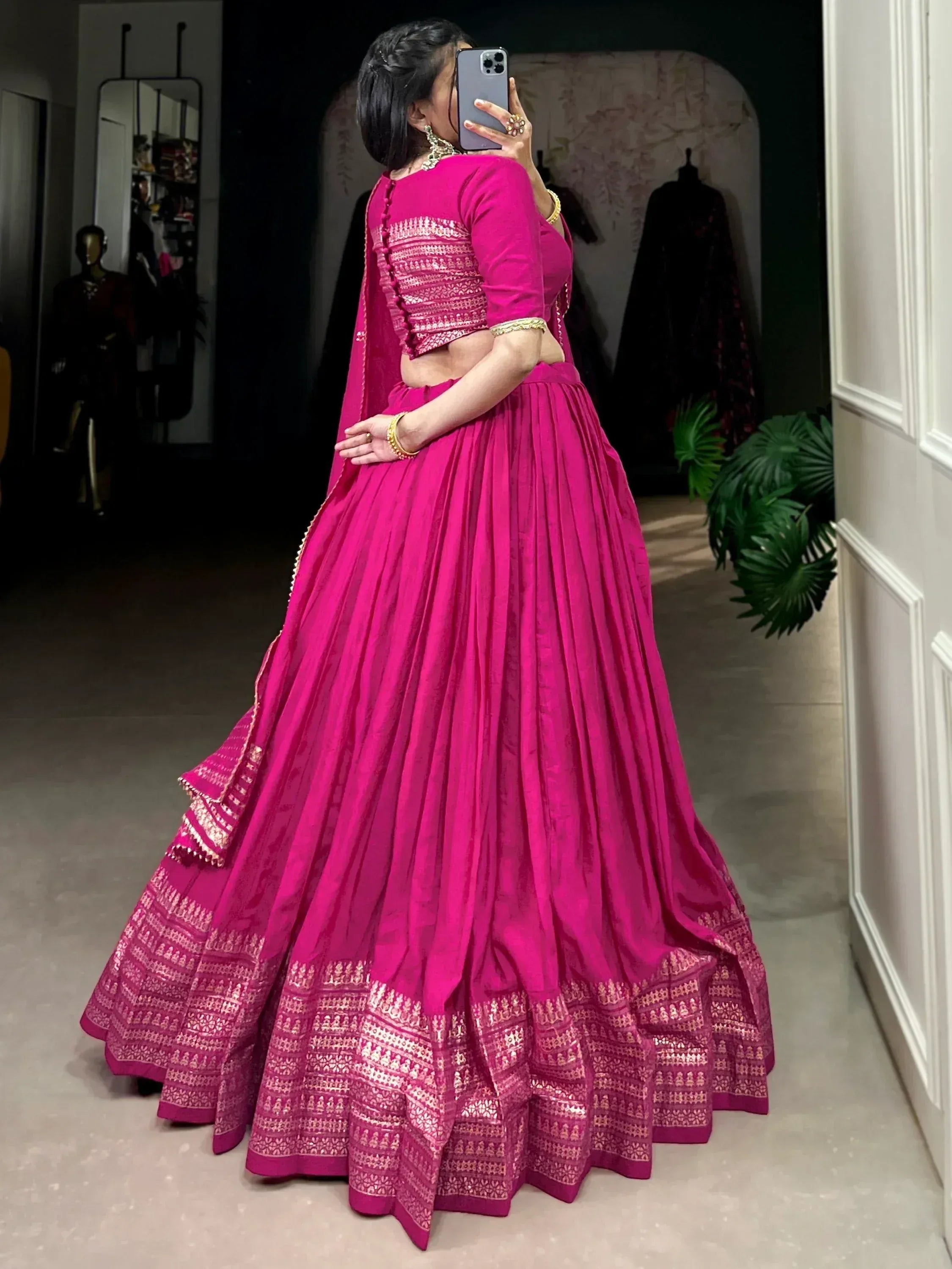 Vibrant pink designer lehenga choli with gold embroidery, perfect for Indian ethnic wear occasions.