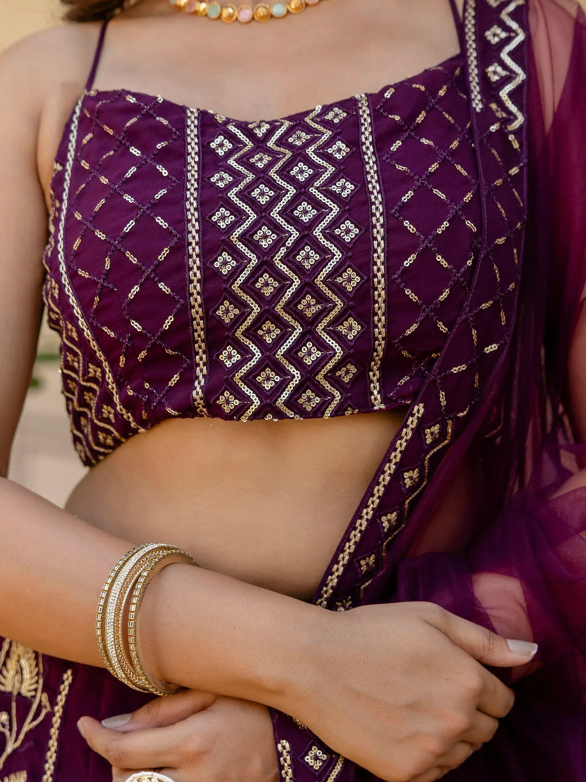 Purple embroidered lehenga choli top with gold detailing, perfect for Indian ethnic wear