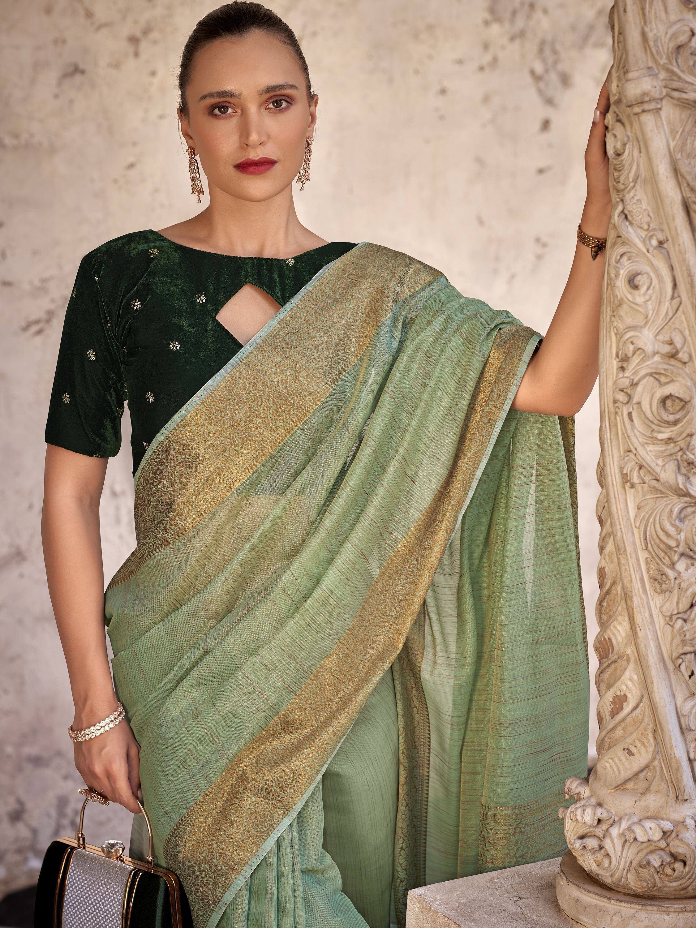 Woman in elegant green saree with gold border and velvet blouse, styled for festive occasions.