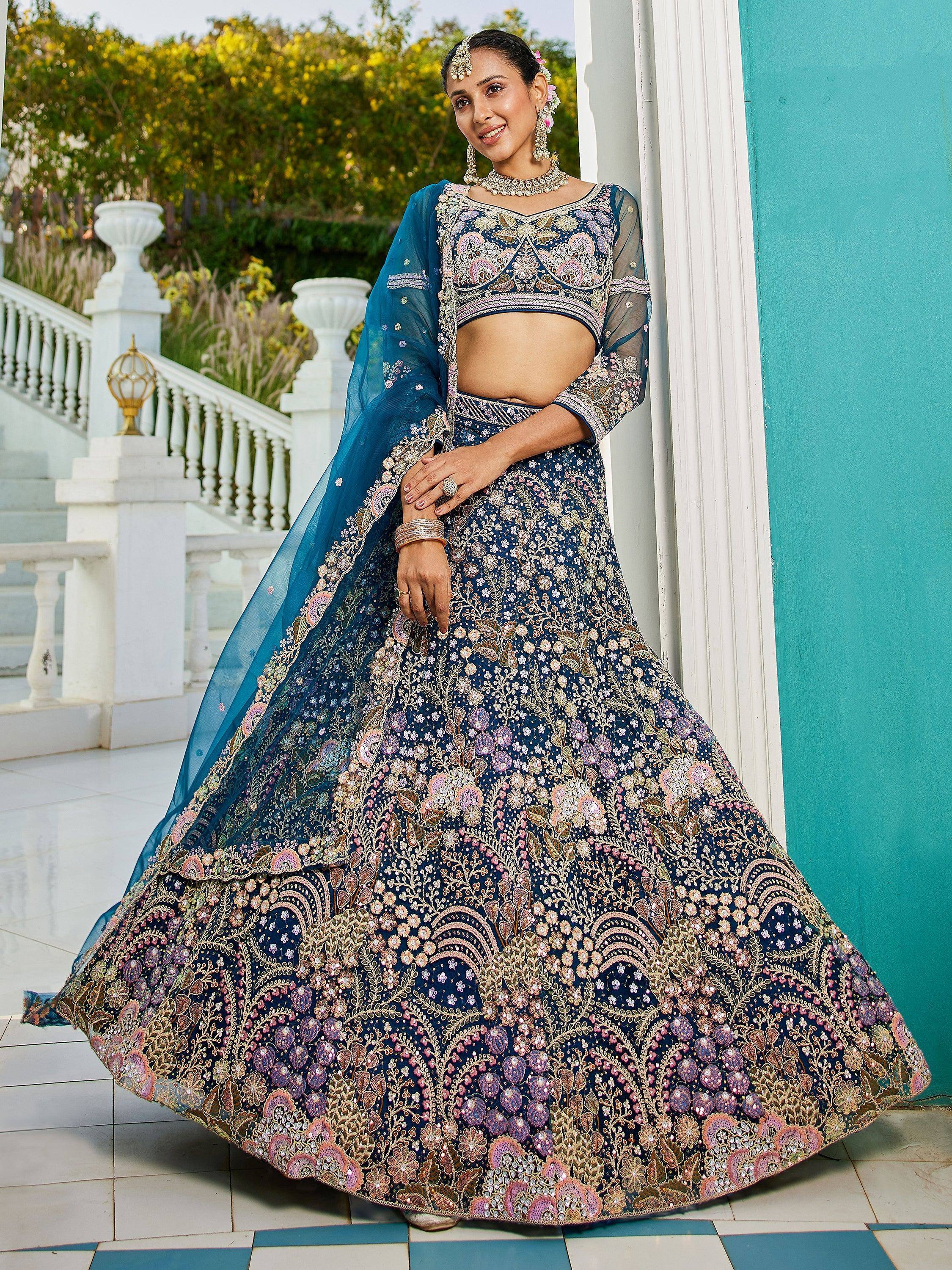 Blue floral embroidered lehenga choli with sheer dupatta, perfect for Indian weddings and festive occasions.