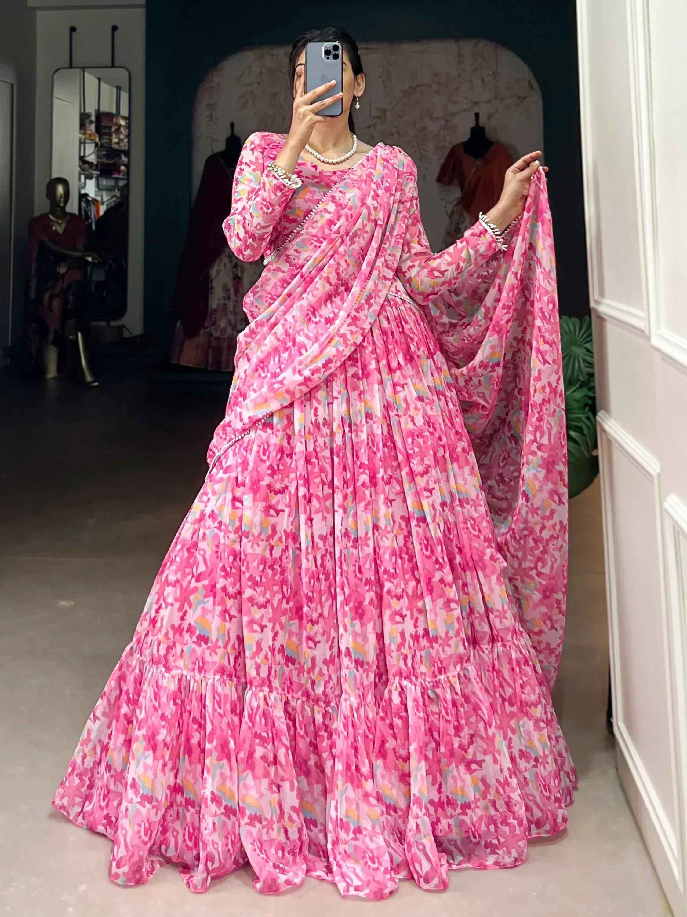 Pink floral print designer lehenga choli with pleated skirt and matching dupatta, perfect for Indian ethnic wear occasions.