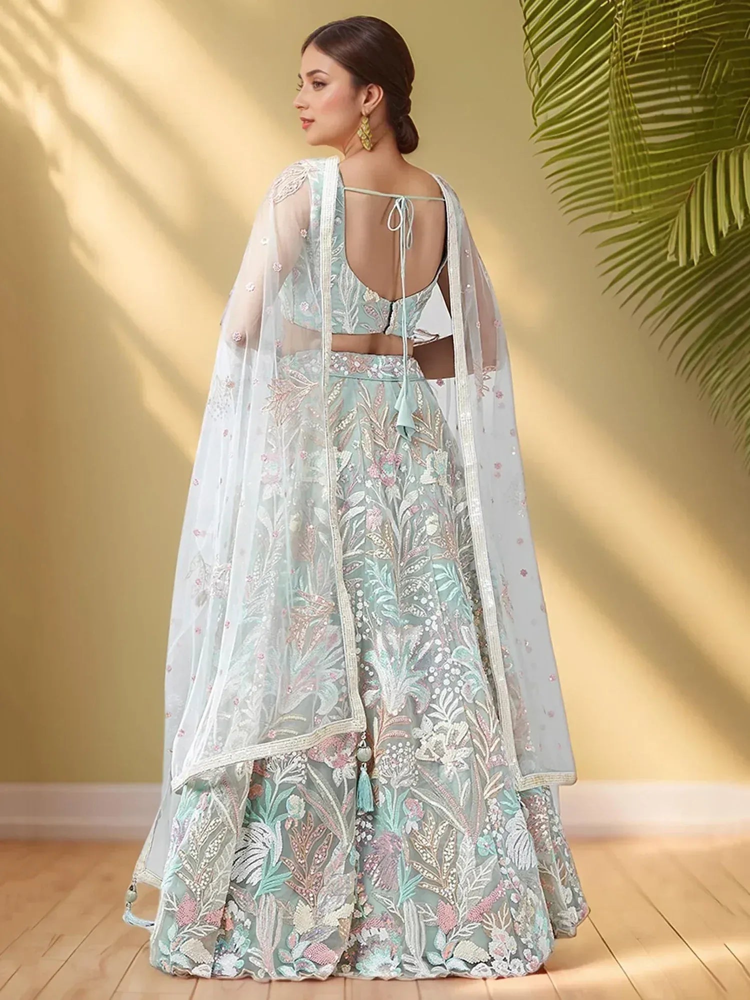Mint green embroidered lehenga choli with floral motifs and sheer dupatta, perfect for Indian ethnic wear occasions.