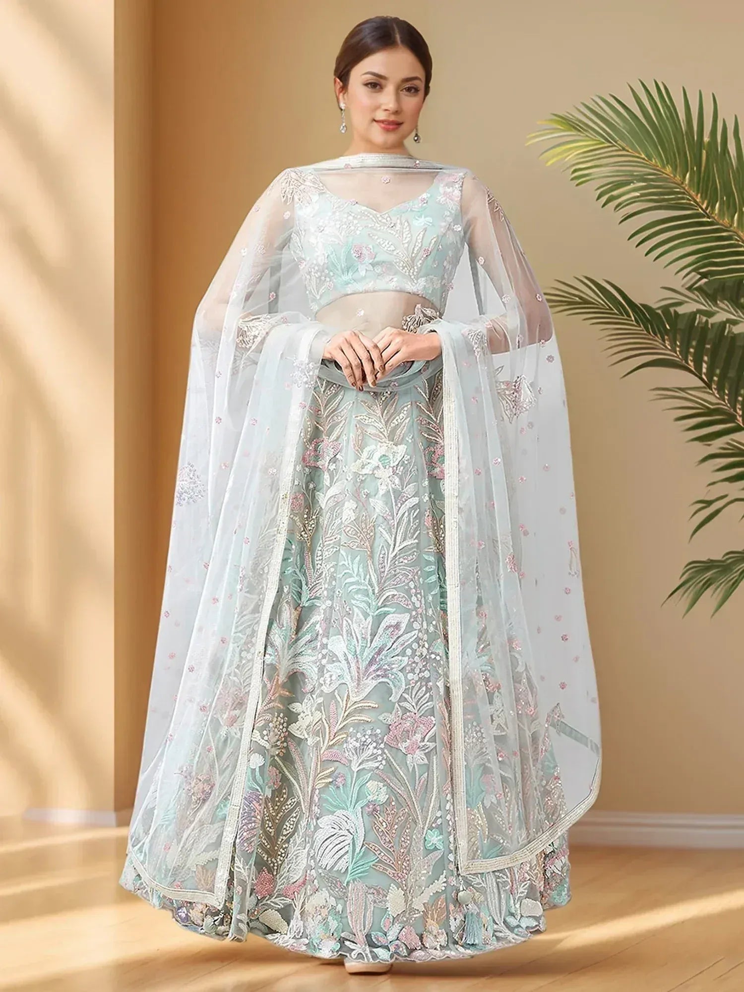 Mint green embroidered lehenga choli with sheer dupatta, floral motifs, perfect for Indian weddings and festive occasions.