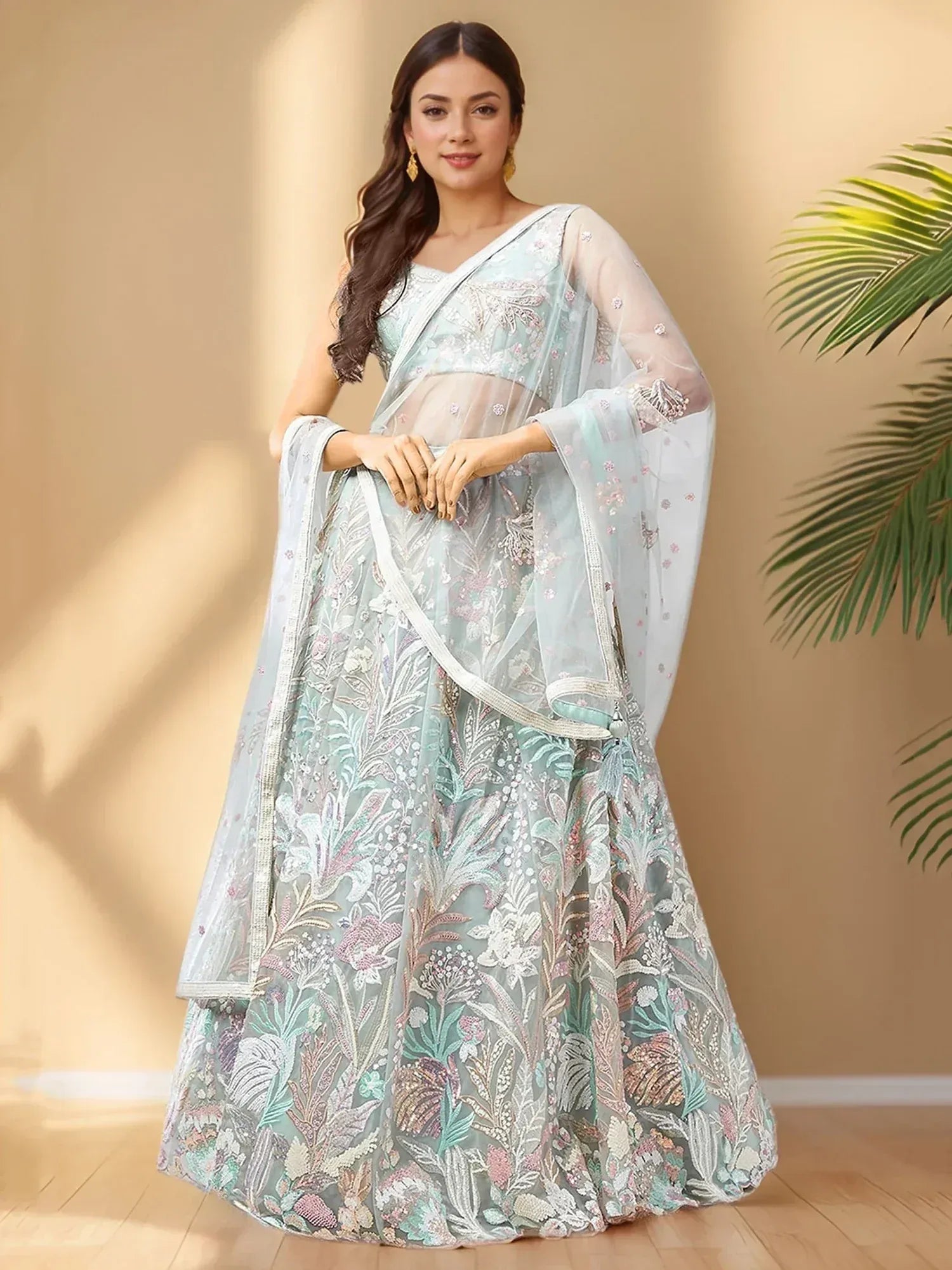 Elegant mint green lehenga choli with floral embroidery and sheer dupatta, perfect for Indian ethnic occasions.