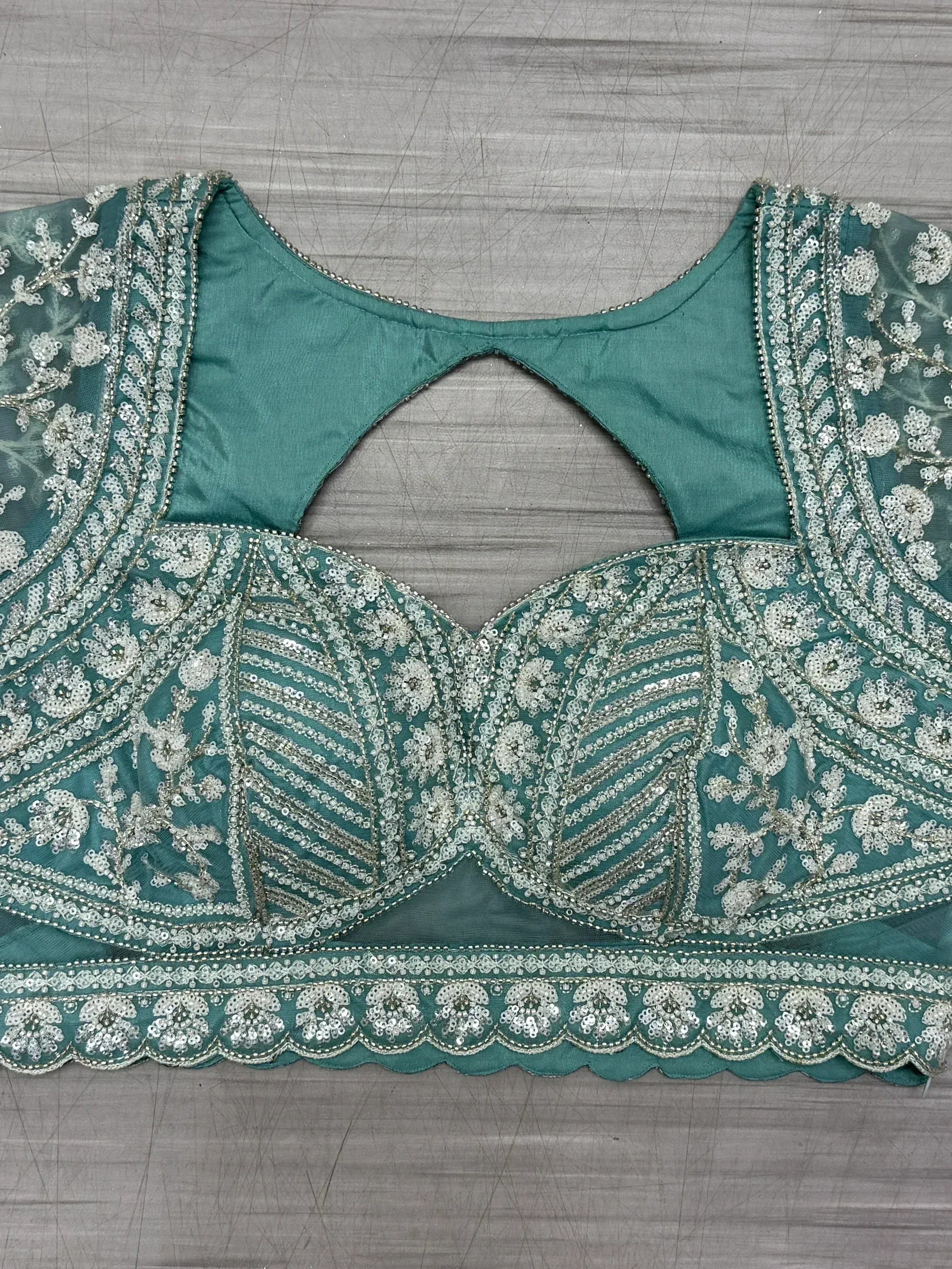 Teal green embroidered blouse with silver sequin floral work, perfect for lehenga choli or saree