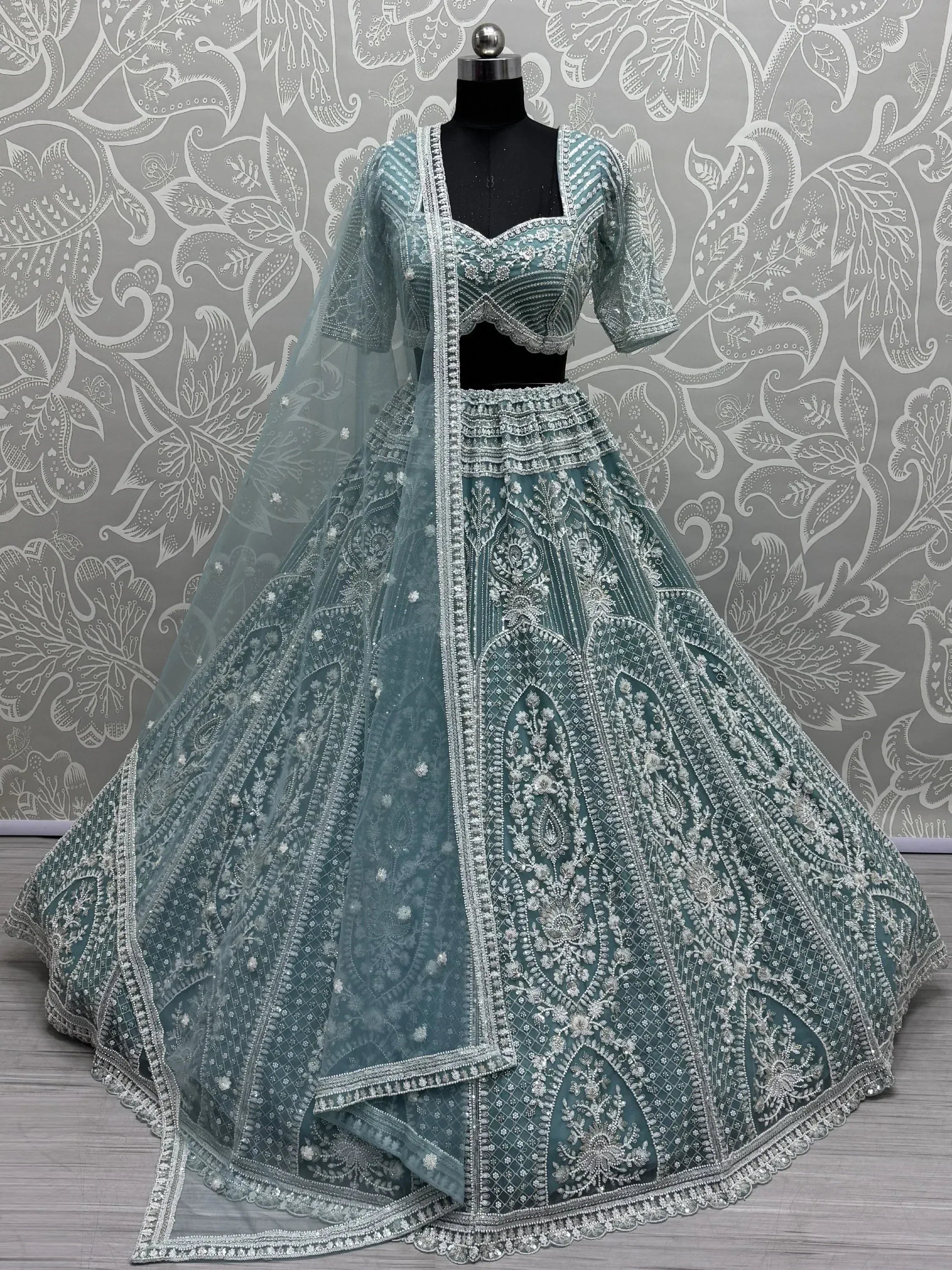 Teal designer lehenga choli with silver embroidery, perfect for weddings and festive occasions.