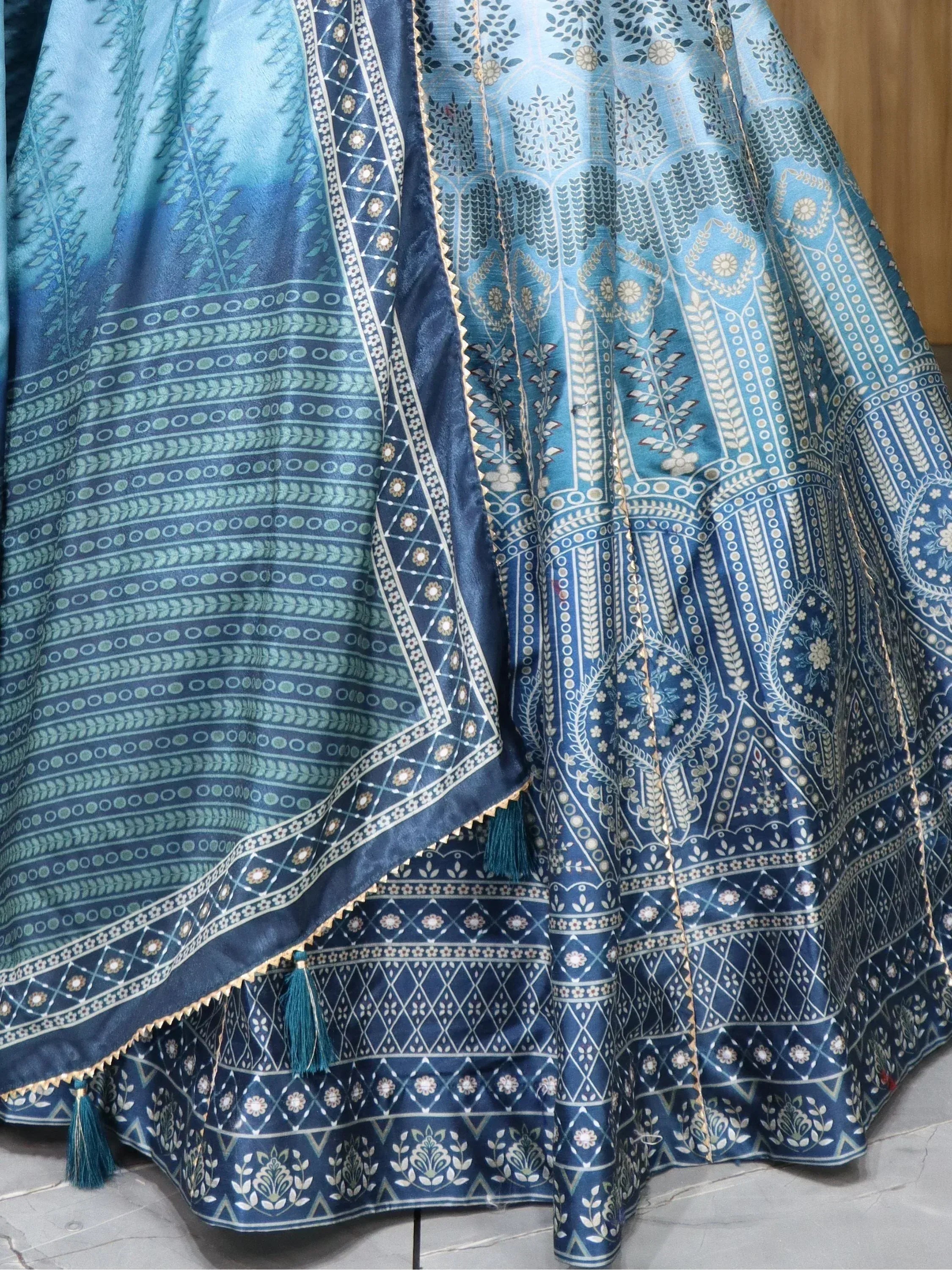 Blue printed lehenga choli with intricate floral patterns and tassels, ethnic Indian wear