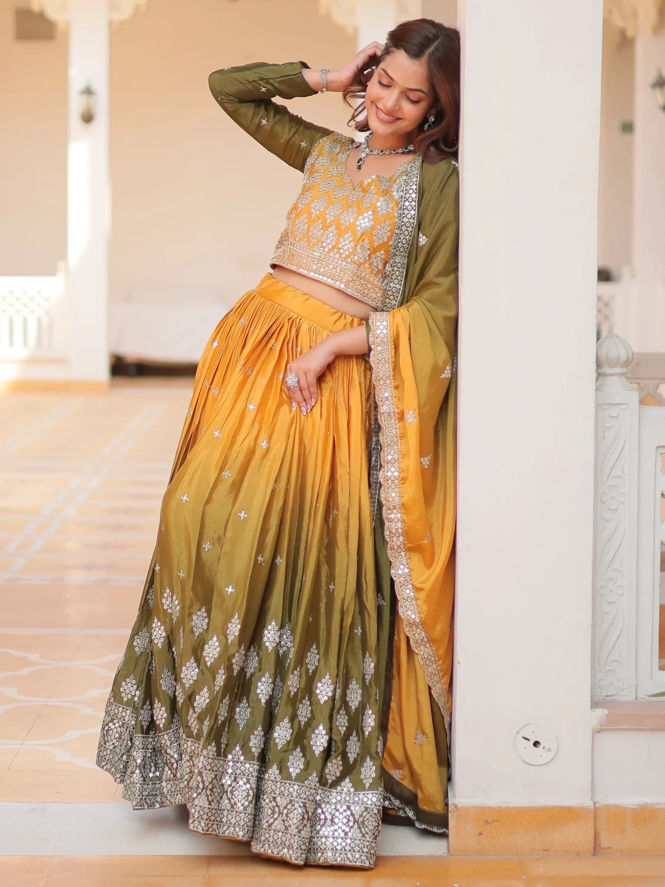 Yellow and olive green designer lehenga choli with silver embroidery, perfect for Indian ethnic wear occasions.