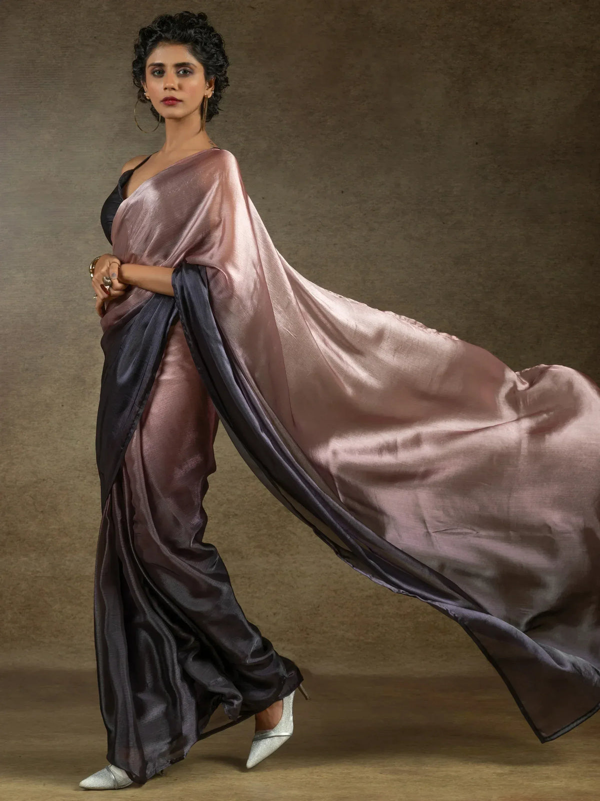 Elegant mauve and black satin saree with flowing drape, styled with silver heels for Indian ethnic wear
