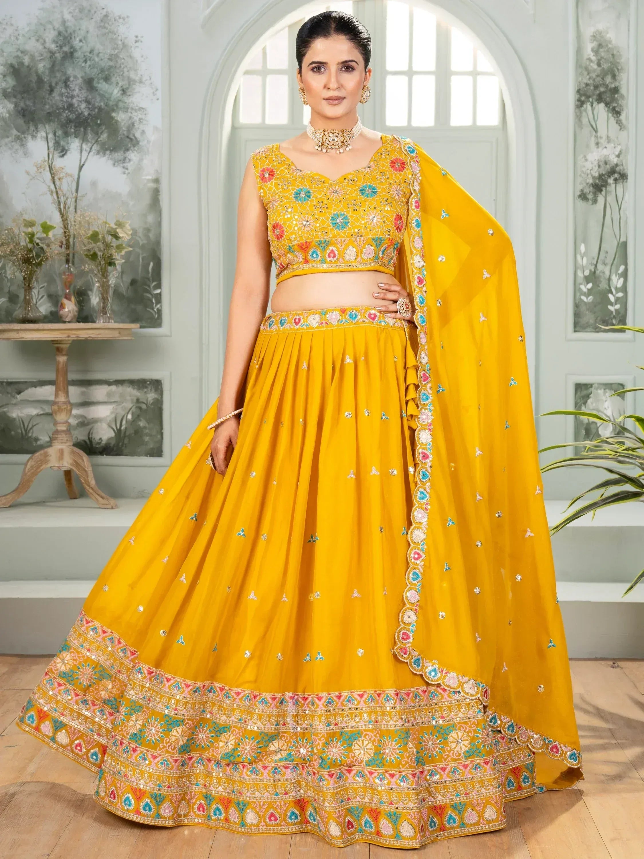 Yellow embroidered lehenga choli with floral motifs and dupatta, ideal for Indian ethnic occasions