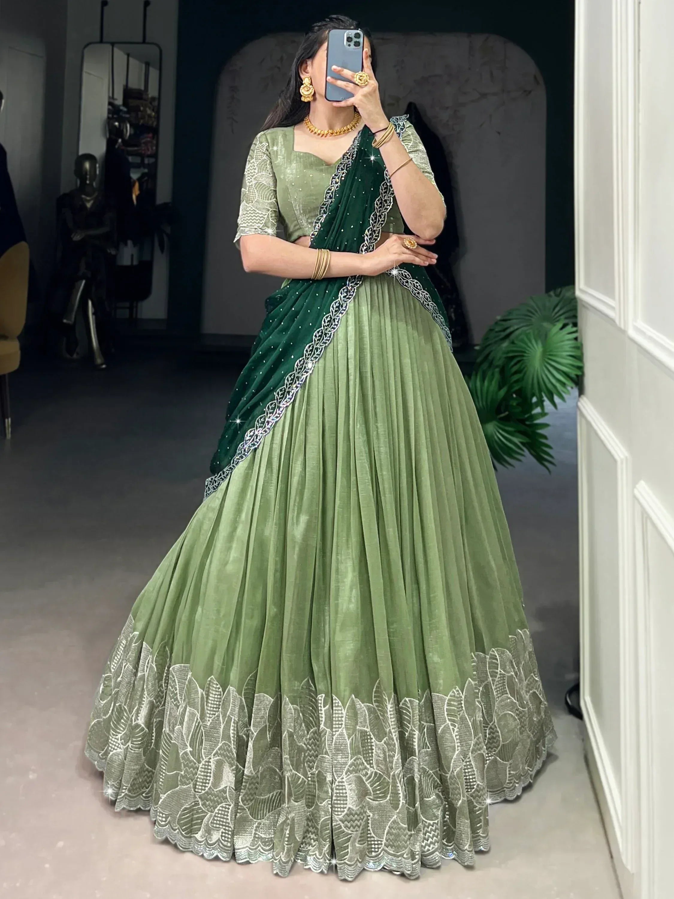 Elegant green designer lehenga choli with intricate embroidery and pleated skirt, perfect for Indian ethnic occasions.