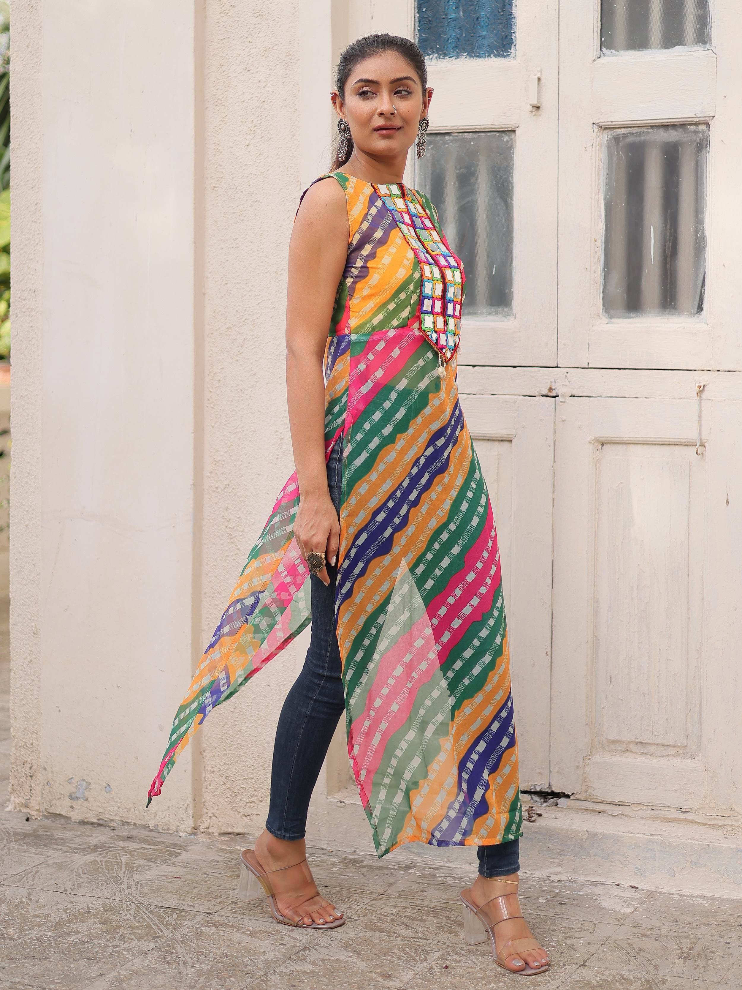 Woman in colorful ethnic printed kurta with mirror work, paired with jeans and heels