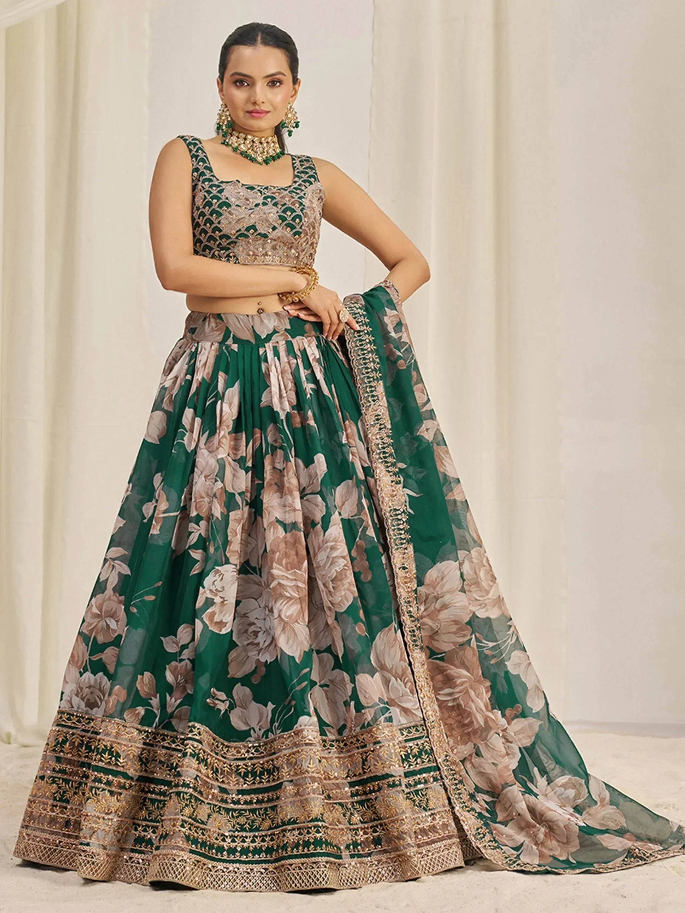 Emerald green floral lehenga choli with gold embroidery, perfect for Indian weddings and festive occasions.