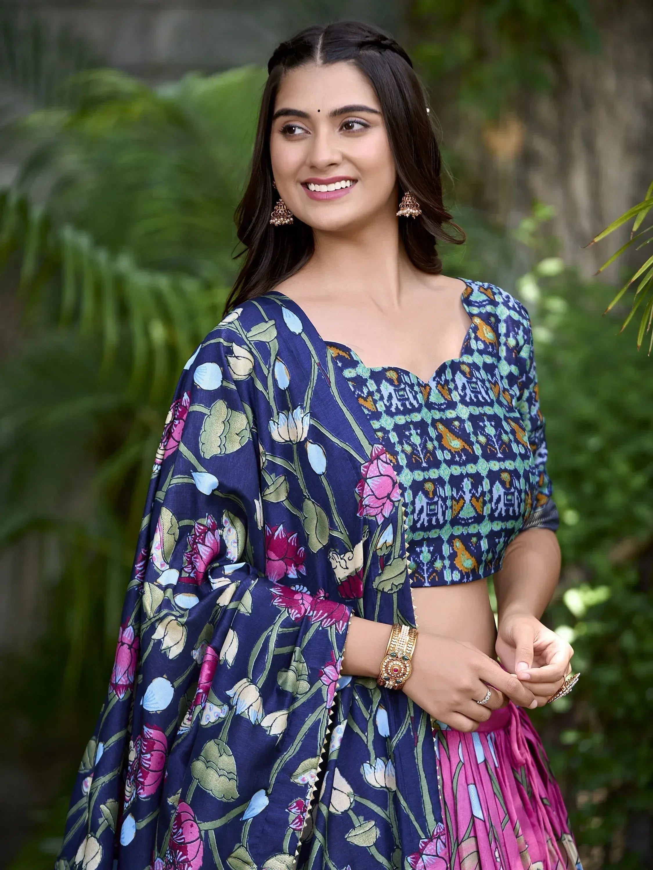 Woman in floral print Indian ethnic lehenga choli with pink skirt, perfect for festive occasions