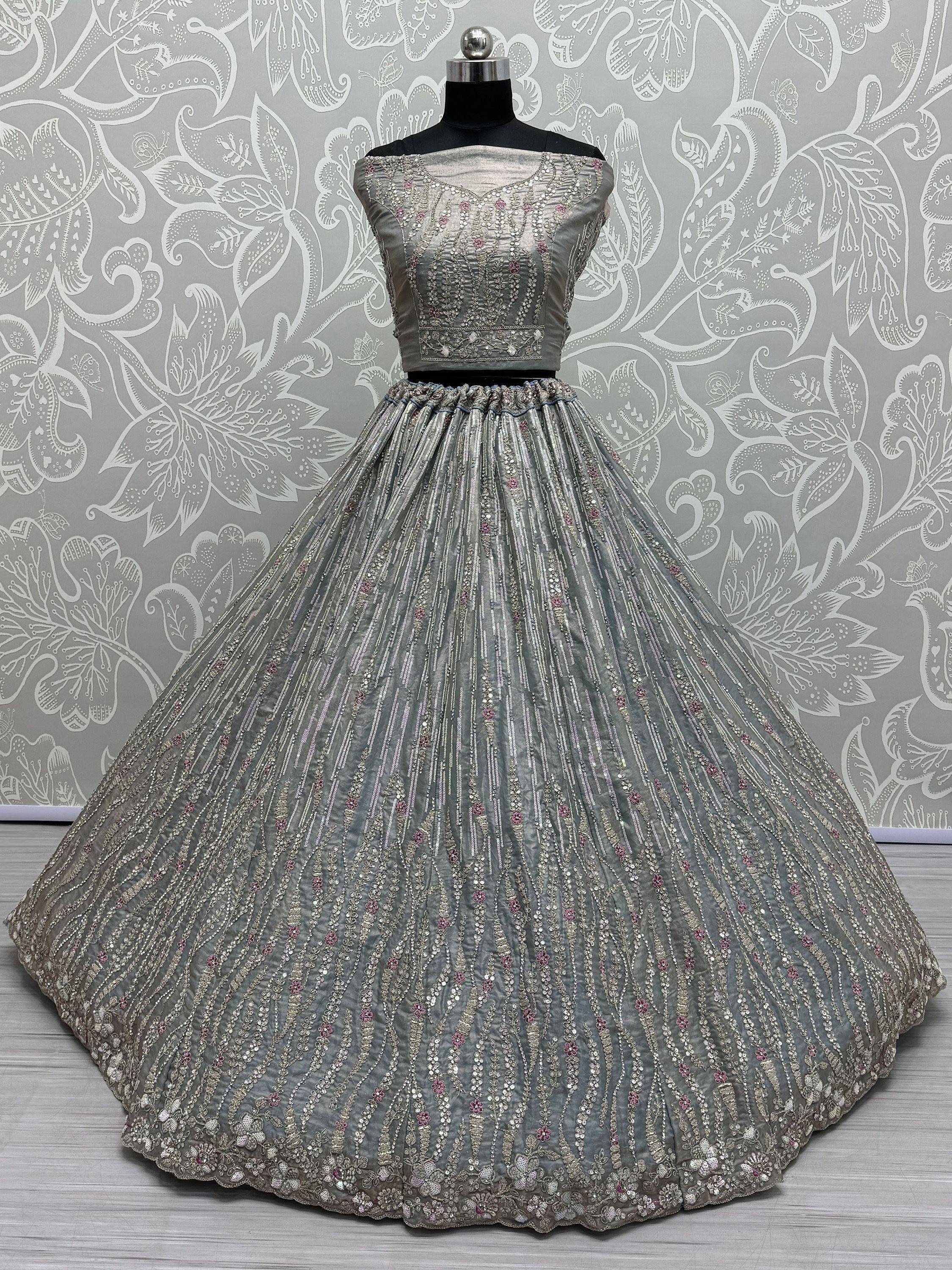 Grey designer lehenga choli with intricate embroidery and sequin work, perfect for Indian ethnic wear occasions.