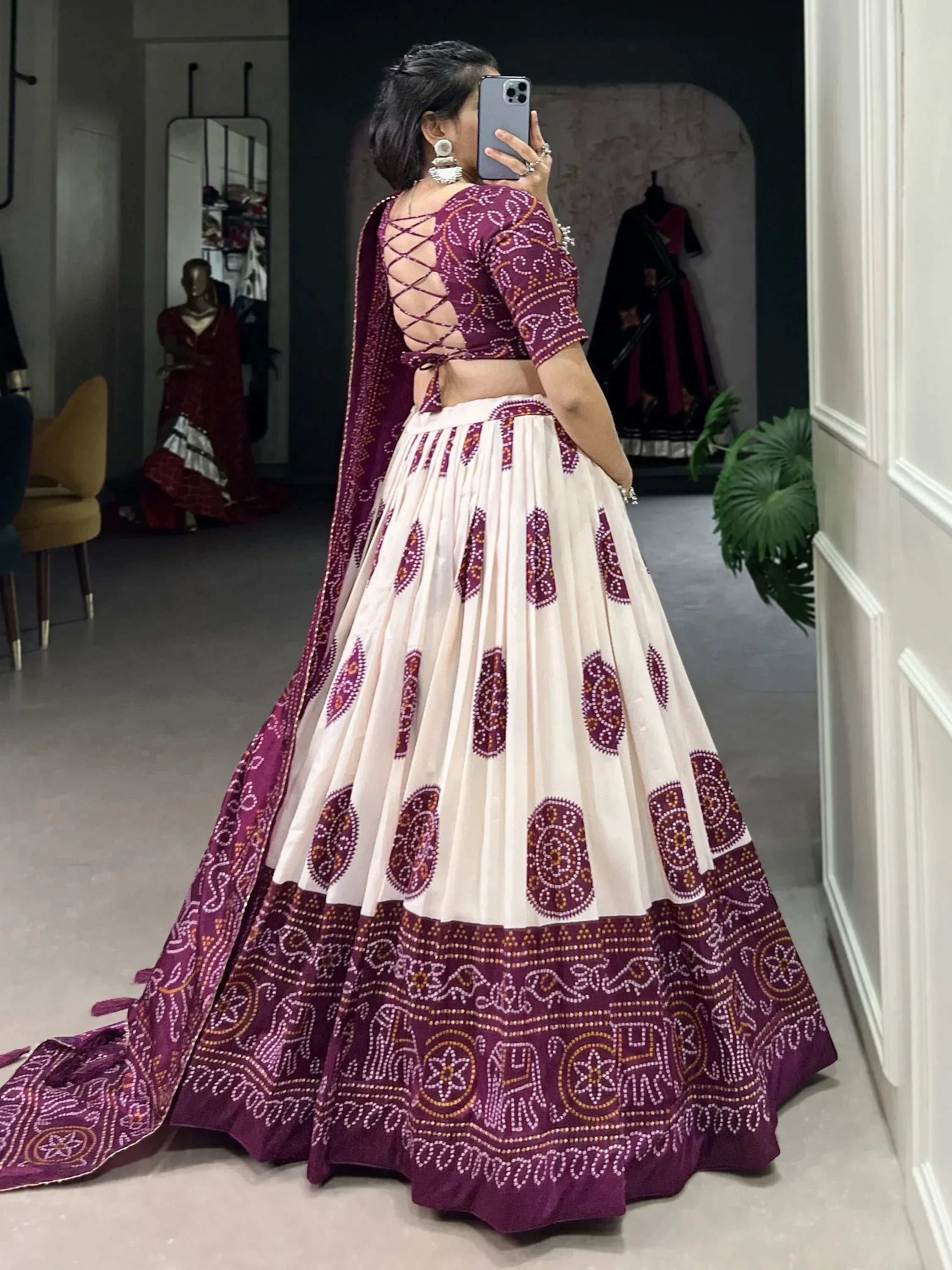 Woman in maroon and cream printed lehenga choli with back lace-up blouse, ethnic wear for weddings
