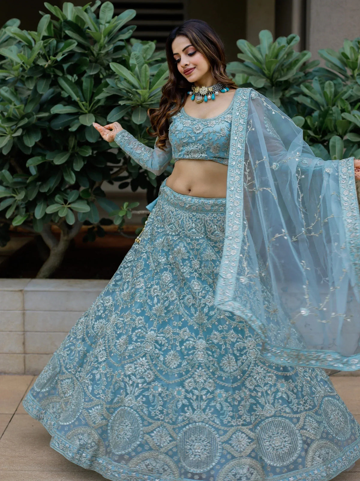 Elegant light blue embroidered lehenga choli with sheer dupatta, perfect for Indian ethnic occasions.