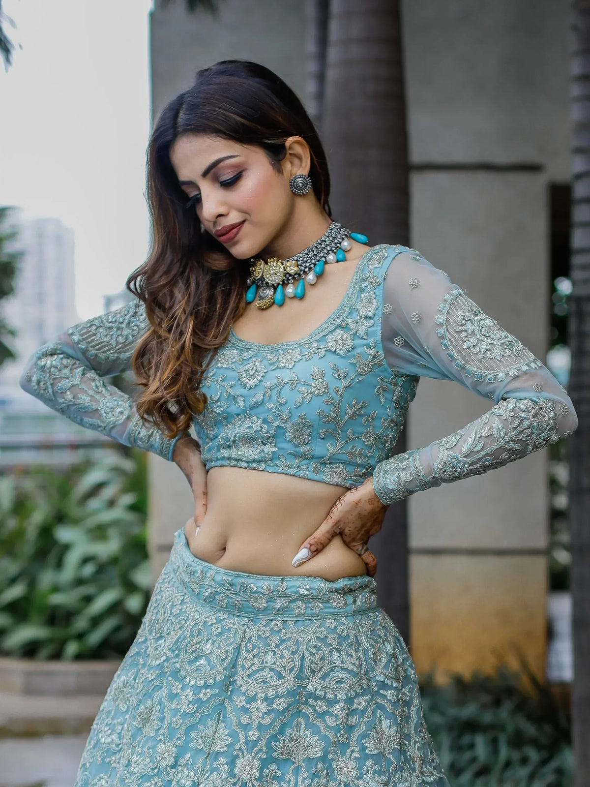 Elegant blue embroidered lehenga choli with sheer sleeves, perfect for Indian ethnic wear occasions.