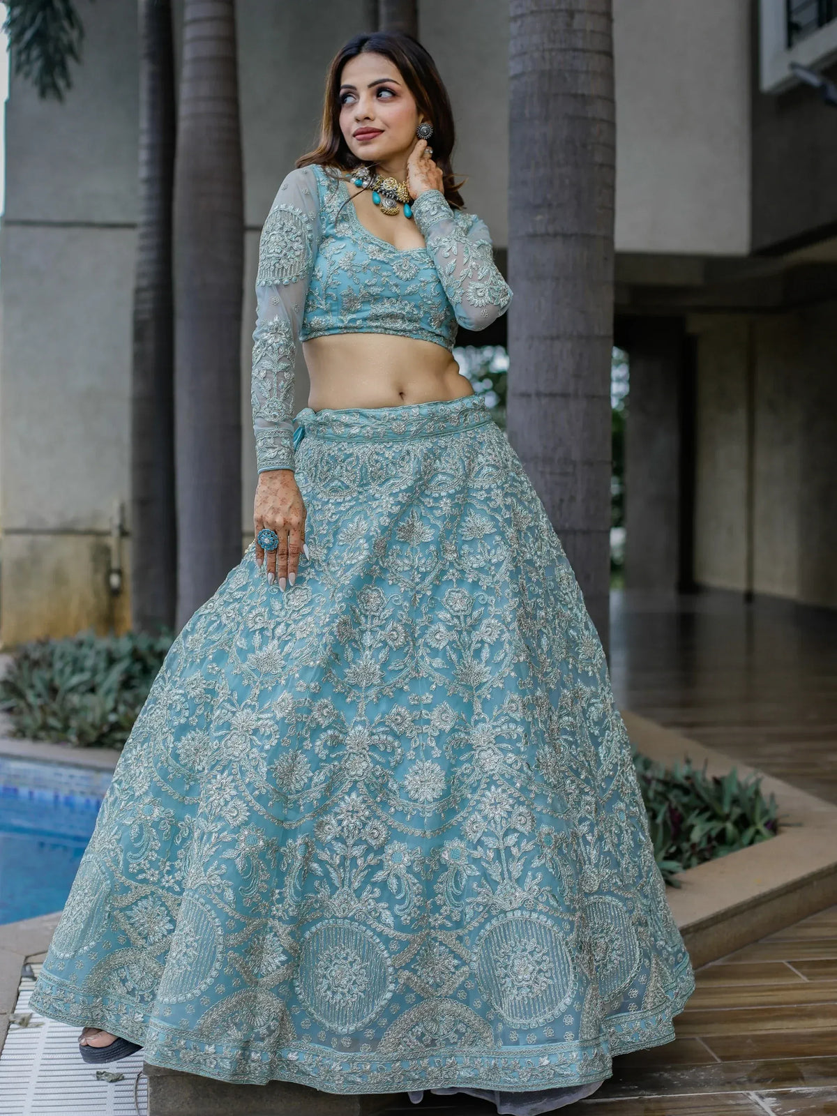 Elegant turquoise lehenga choli with silver embroidery, perfect for Indian ethnic occasions