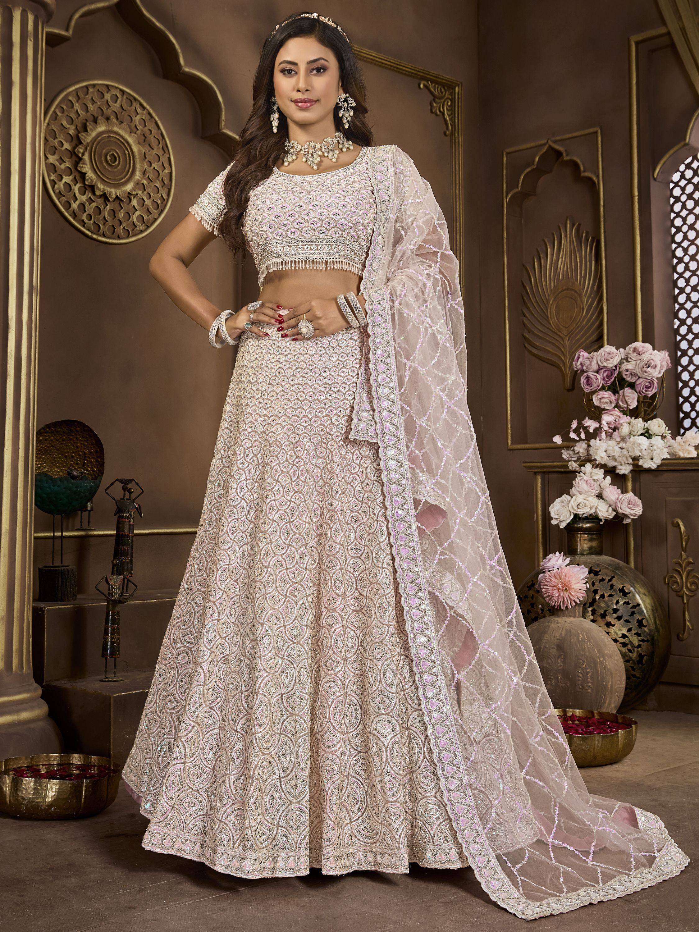 Elegant ivory lehenga choli with intricate embroidery and sheer dupatta, perfect for Indian weddings and festive occasions.