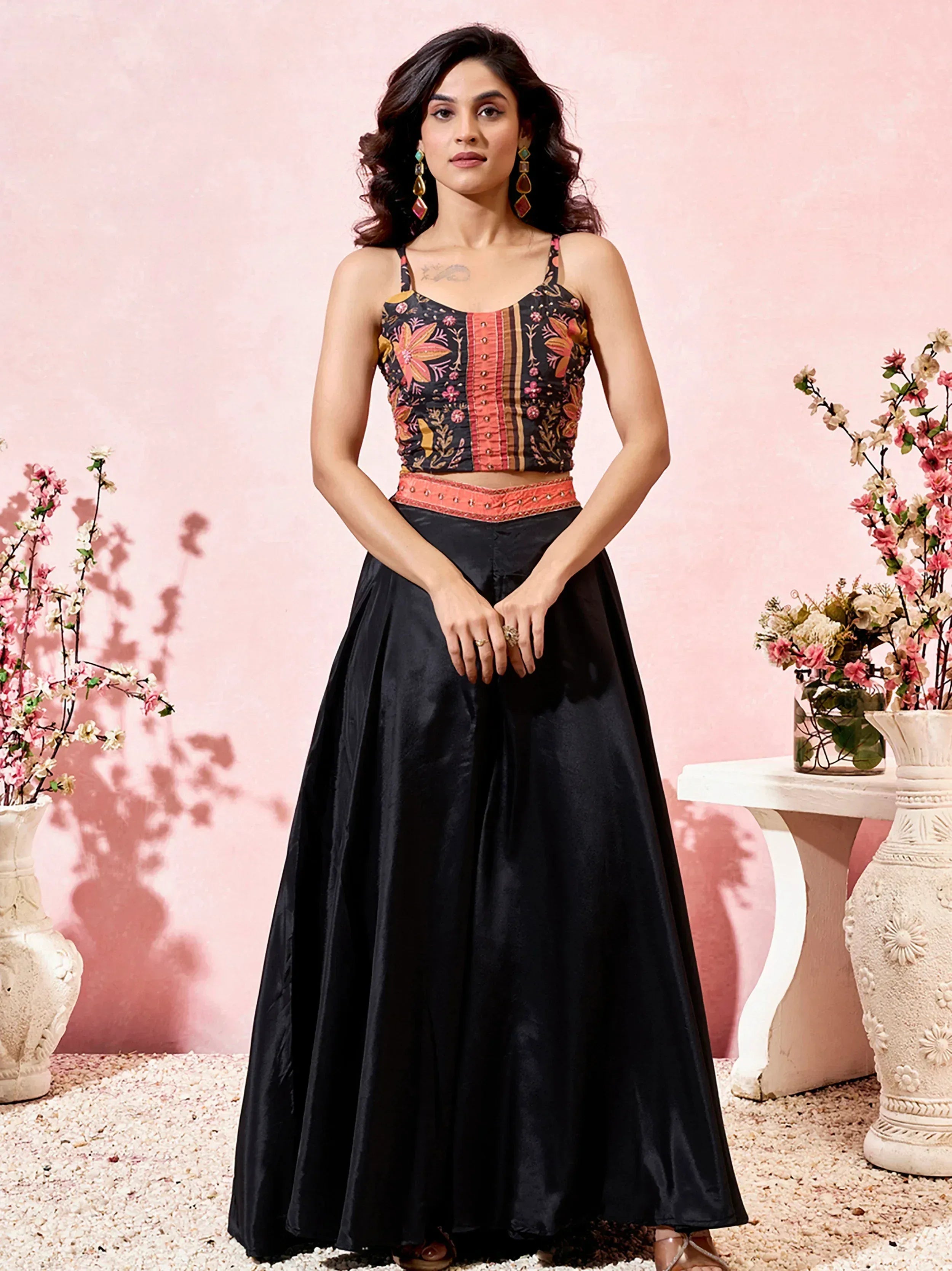 Black floral embroidered lehenga choli with orange waistband, perfect for Indian ethnic occasions