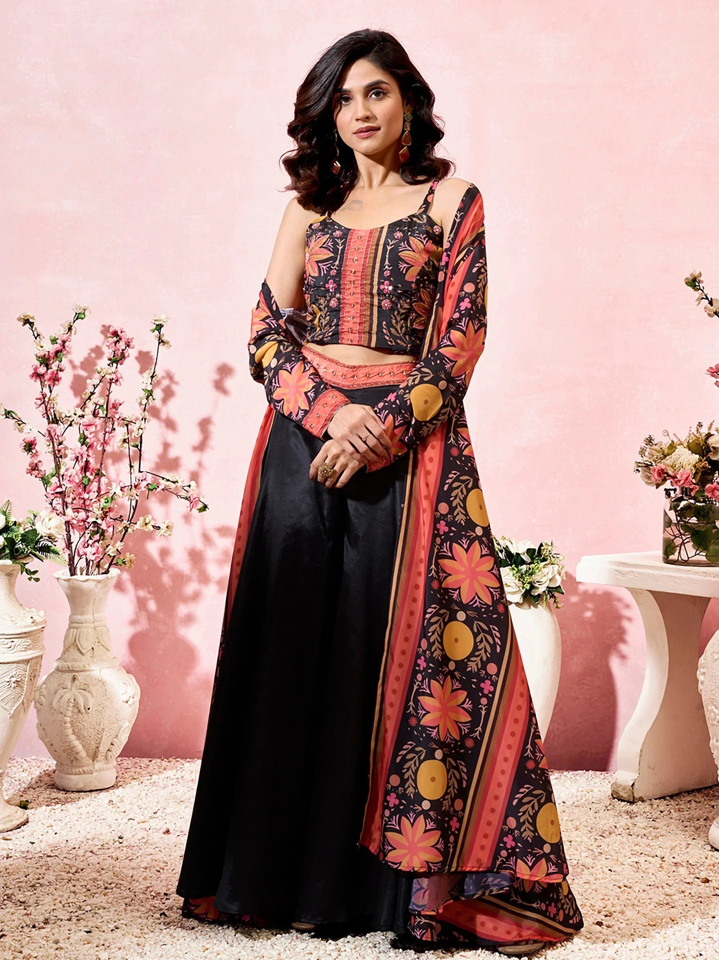 Woman in black floral print ethnic wear with crop top and palazzo pants, perfect for Indian festivals and occasions.