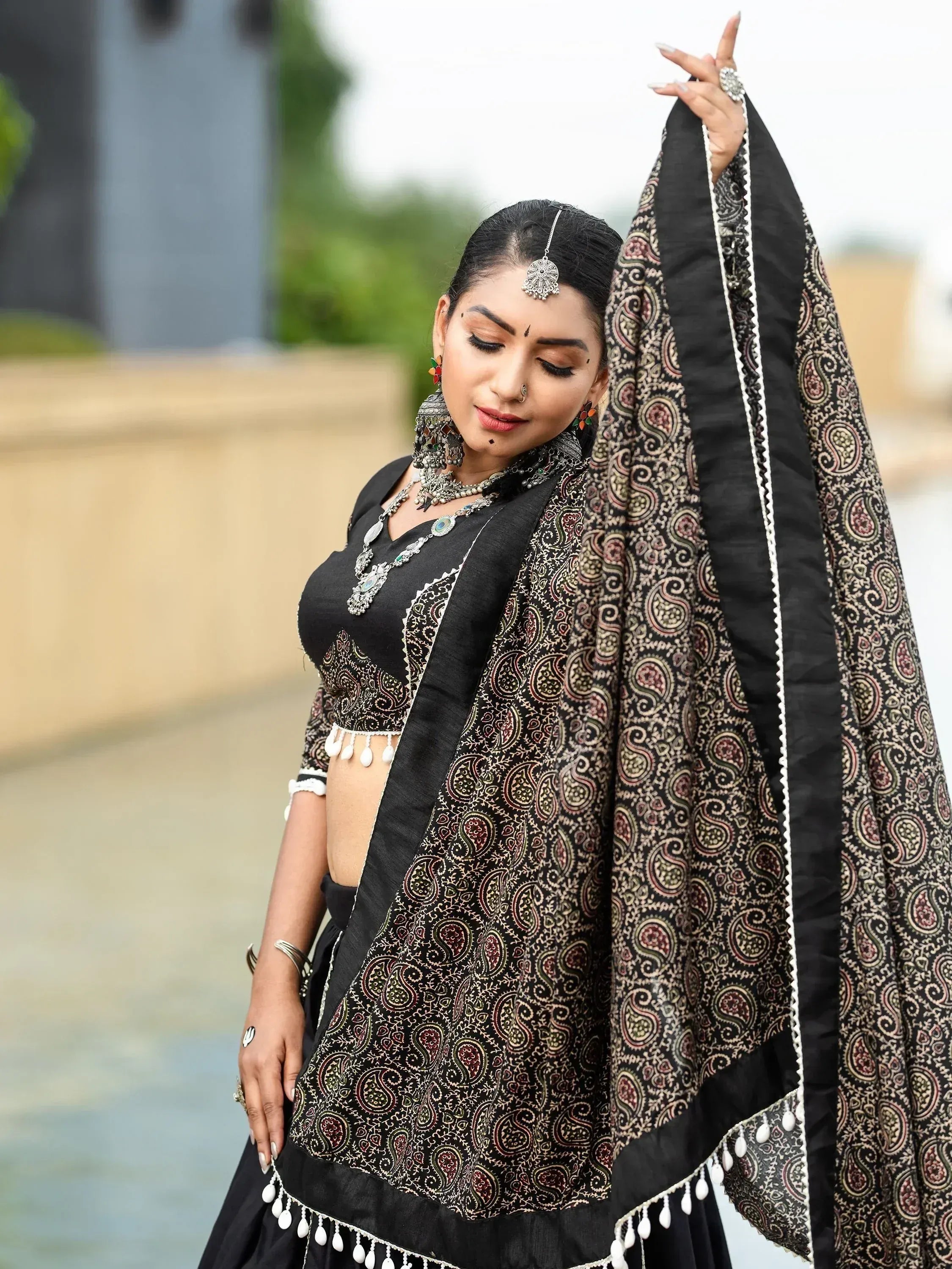 Black paisley print lehenga choli with silver jewelry, ethnic Indian wear