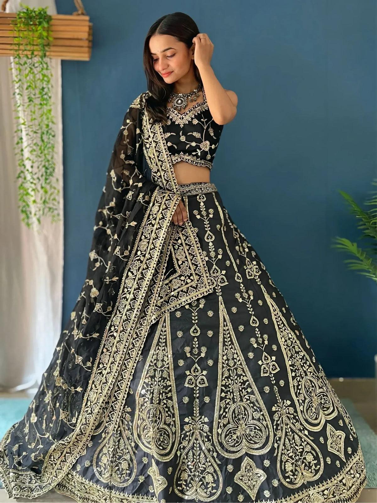 Black and gold embroidered lehenga choli with floral motifs, perfect for Indian ethnic wear occasions.