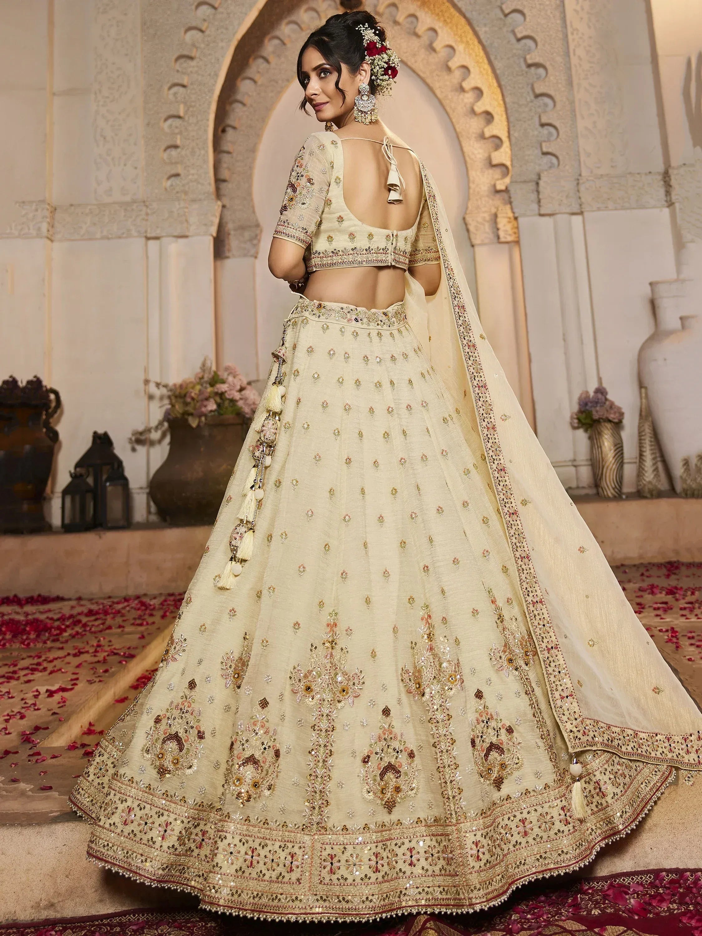Elegant cream lehenga choli with floral embroidery, perfect for Indian weddings and festive occasions.