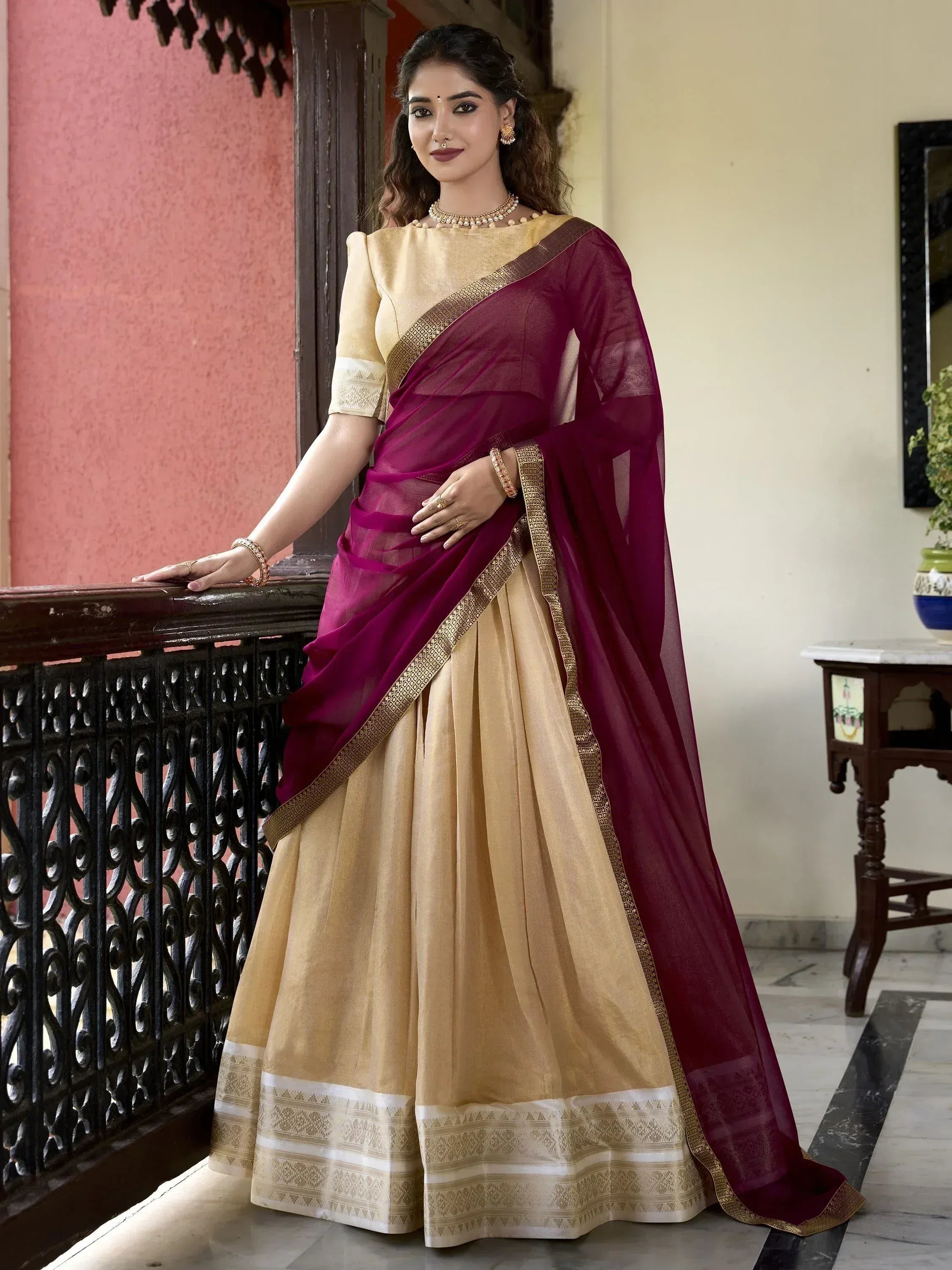 Elegant maroon and gold saree with intricate border, perfect for Indian ethnic occasions