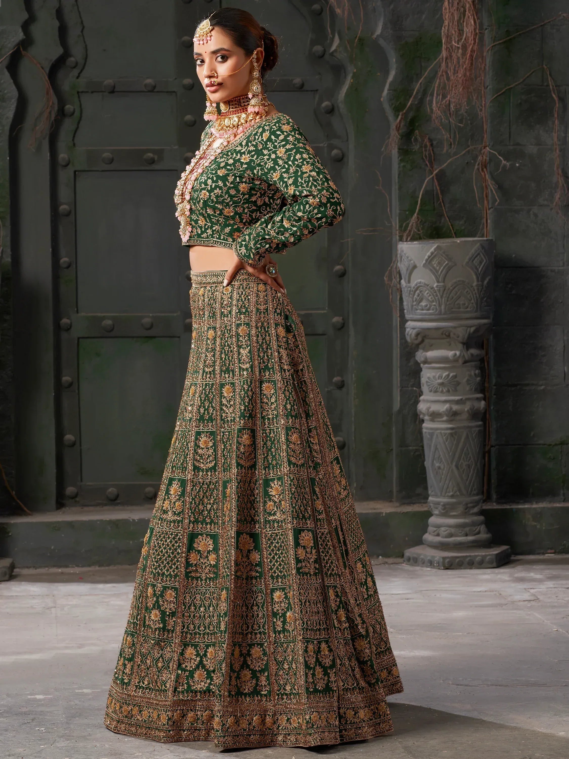 Emerald green designer lehenga choli with gold embroidery, perfect for Indian weddings and festive occasions.