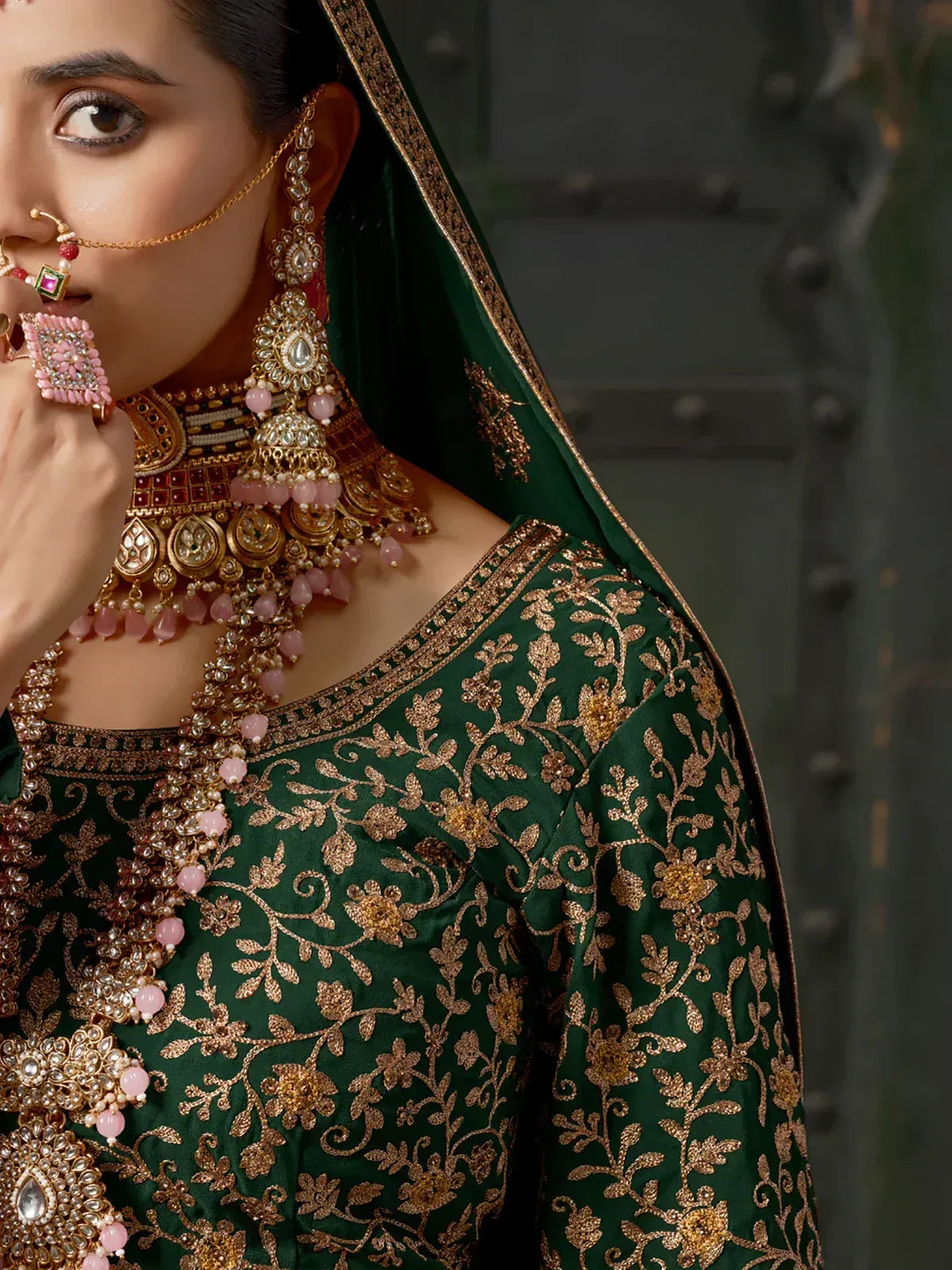Emerald green ethnic wear with gold floral embroidery and pink stone jewelry