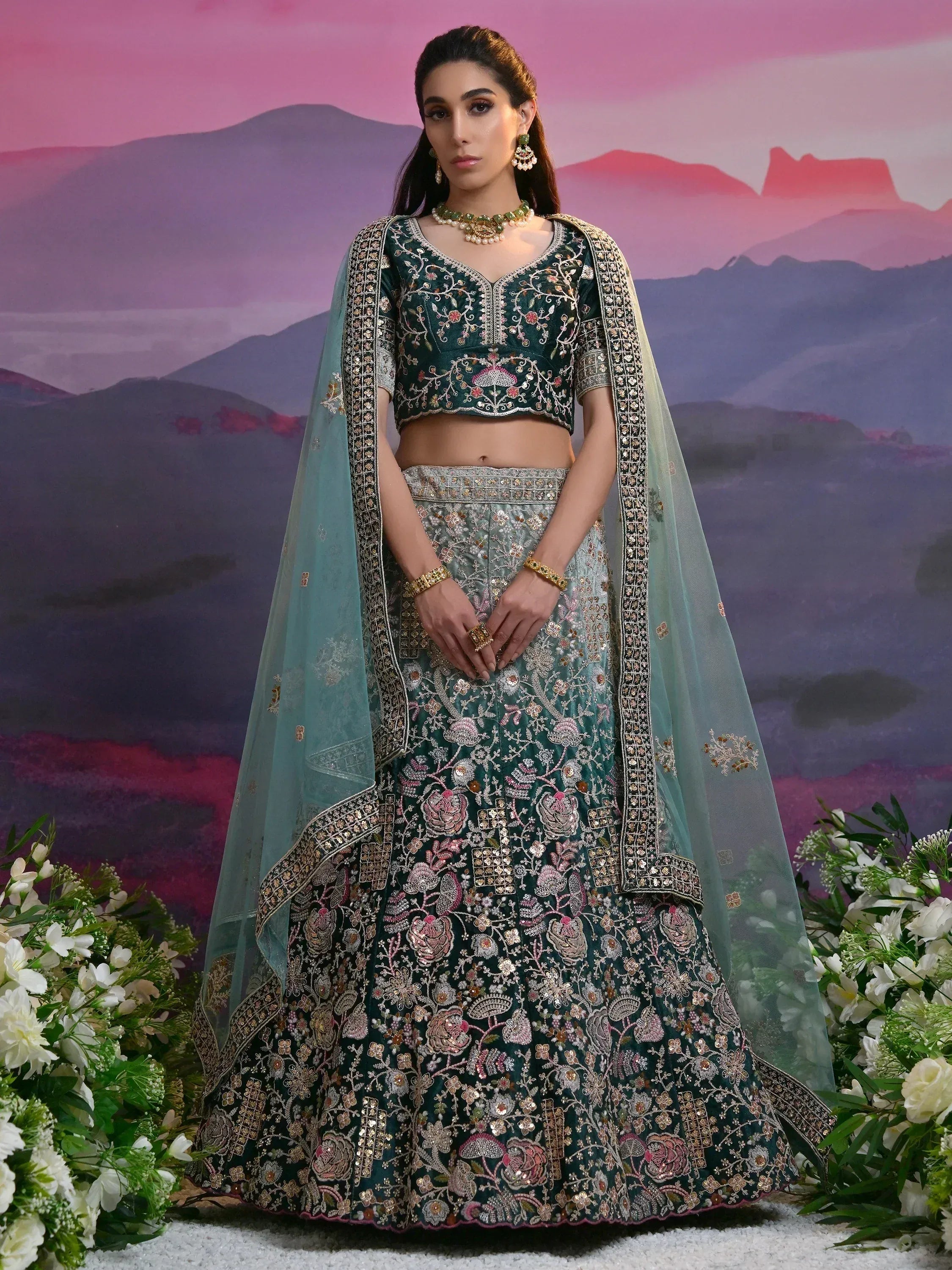 Emerald green embroidered lehenga choli with floral motifs and sheer dupatta, perfect for Indian weddings and festive occasions.